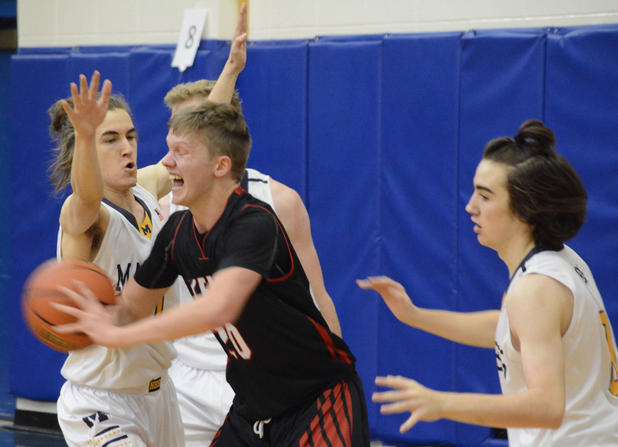 Kenai Central’s Andrew Bezdecny tries to break away from the Homer defense Friday, Dec. 21, 2018, at the Homer High School Alice Witte Gym in Homer, Alaska. (Photo by Michael Armstrong/Homer News)