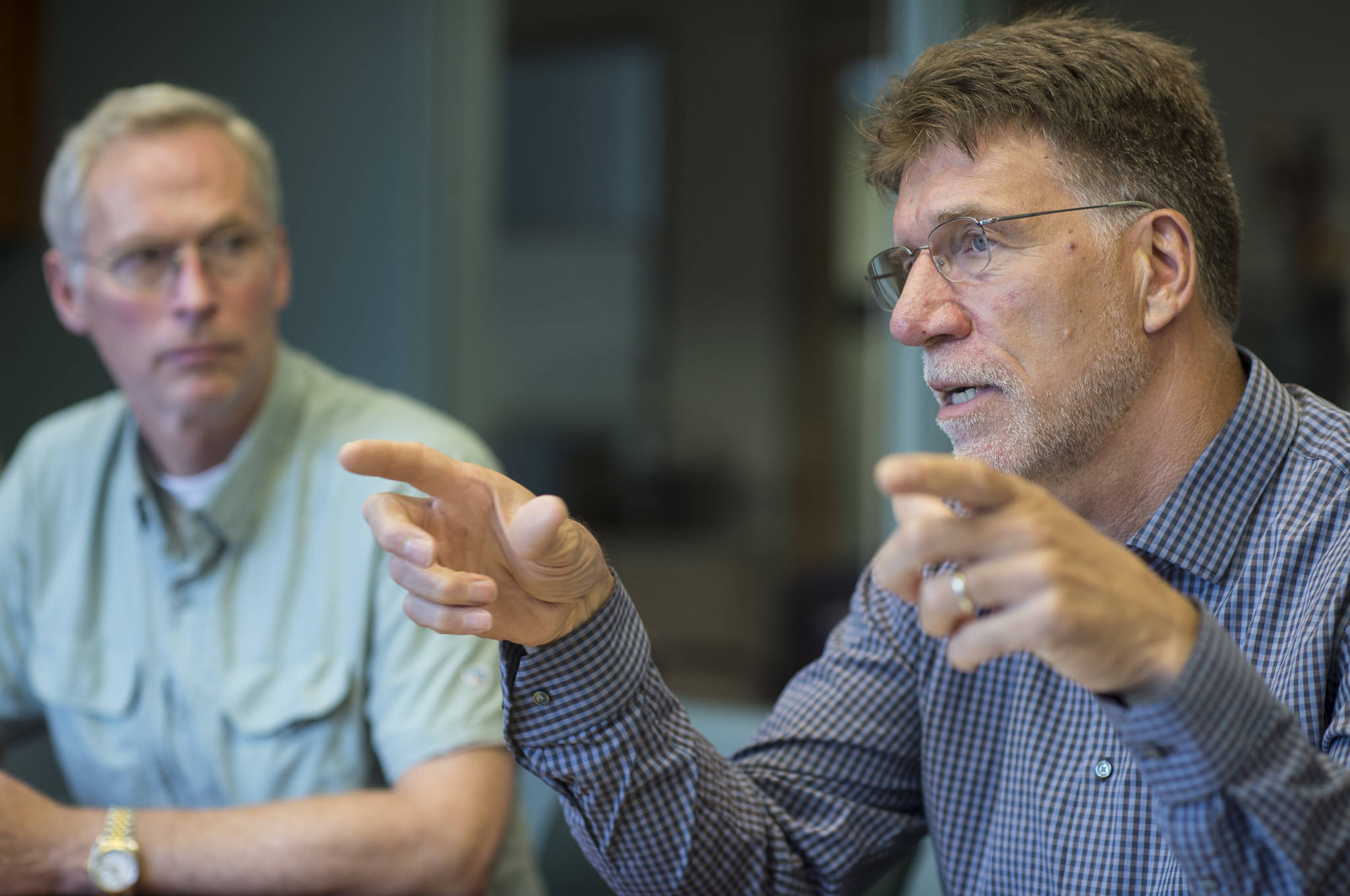 University of Alaska President Jim Johnsen, left, listens to Dr. Steve Atwater, Executive Dean of the Alaska College of Education, during an interview at the University of Alaska Southeast on Friday, Aug. 3, 2018. (Michael Penn | Juneau Empire File)