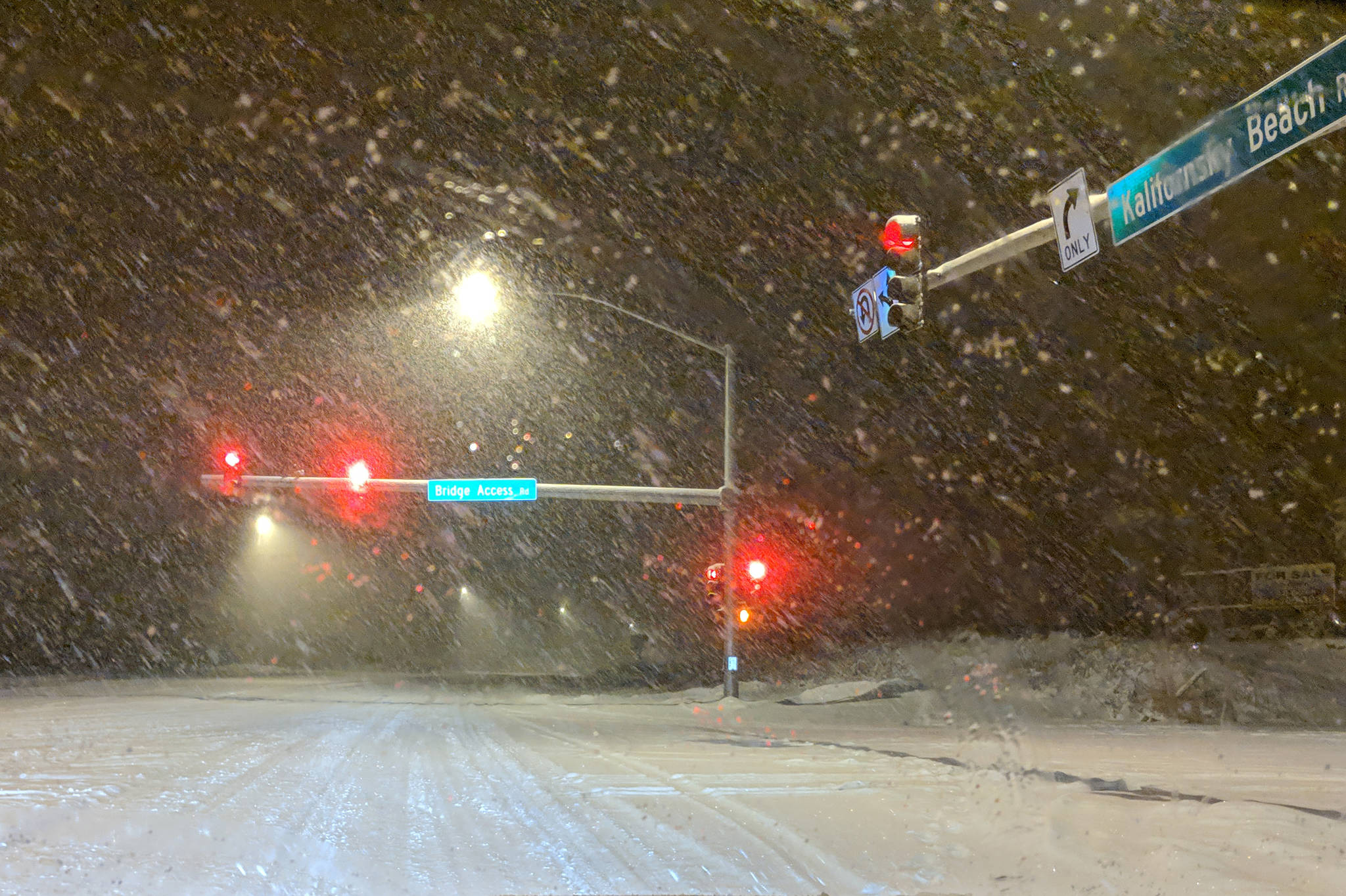 The intersection of Bridge Access Road and Kalifornsky Beach Road is covered with blowing snow on Friday, Dec. 14, 2018, in Kenai, Alaska. A winter storm that brought more than a foot of snow to some areas of the peninsula made for hazardous driving conditions over the weekend. (Photo by Erin Thompson/Peninsula Clarion)