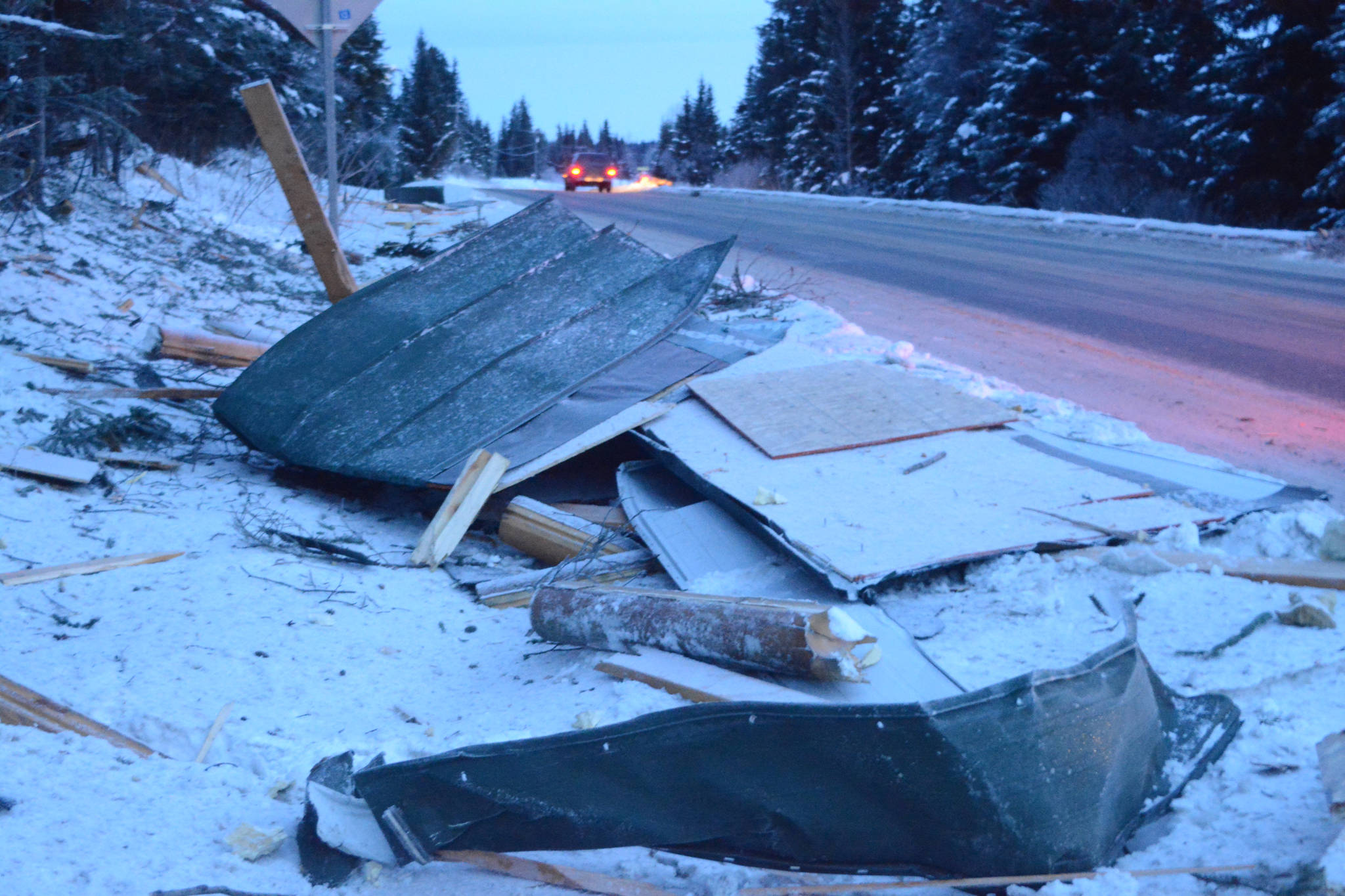 Debris from an exploded house is piled by the road near Mile 166 Sterling Highway on Friday, Dec. 28, 2018, near Homer, Alaska. The debris field from the explosion spread at least 200 feet in all directions. (Photo by Michael Armstrong/Homer News).
