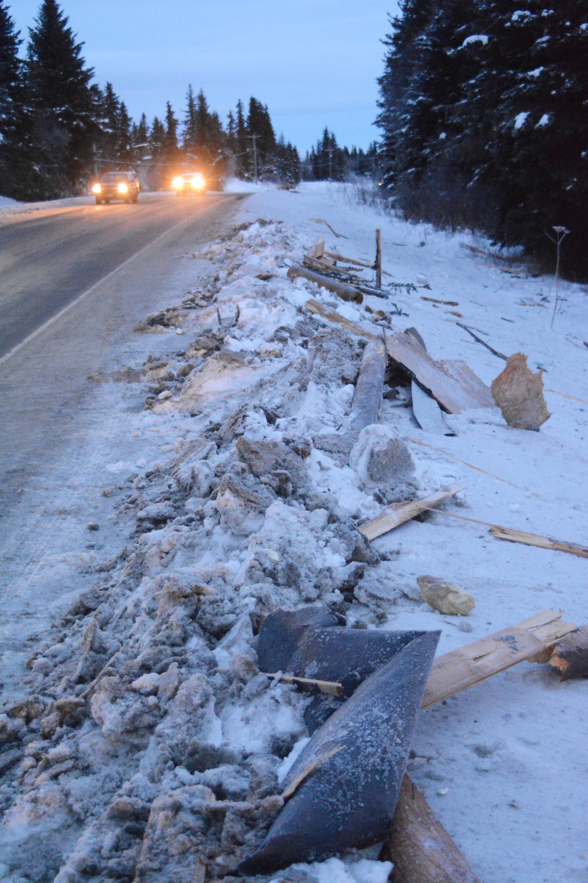 Debris from an exploded house lines the road near Mile 166 Sterling Highway on Friday, Dec. 28, 2018, near Homer, Alaska. The debris field from the explosion spread at least 200 feet in all directions. (Photo by Michael Armstrong/Homer News).