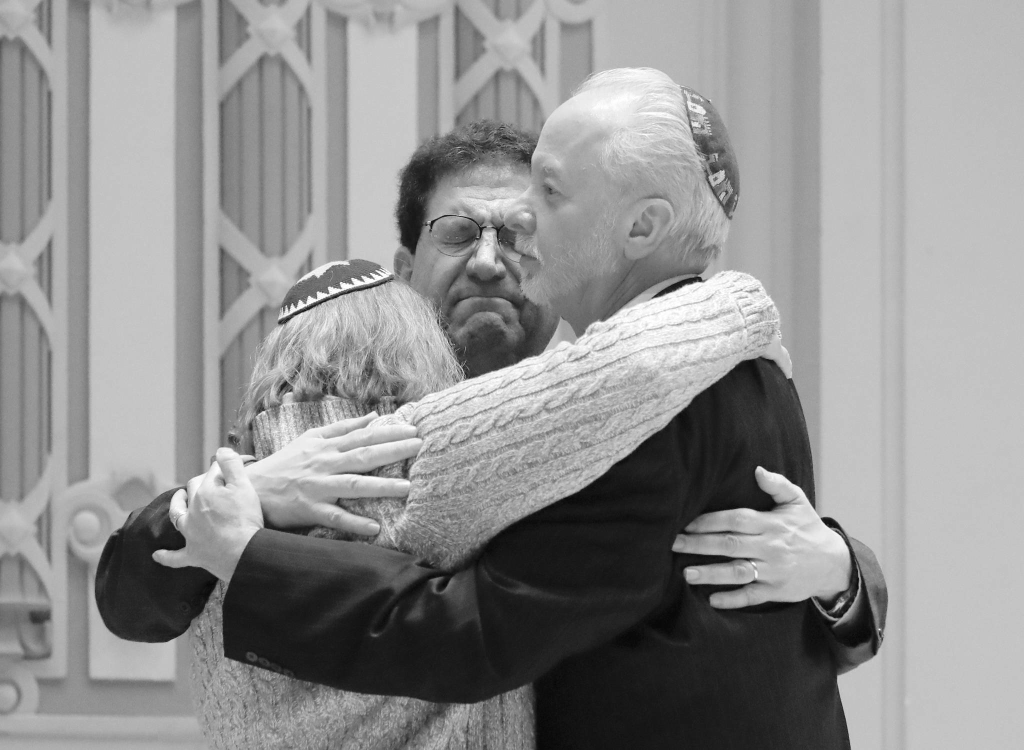 In this Oct. 28 file photo, Rabbi Jeffrey Myers, right, of Tree of Life/Or L’Simcha Congregation hugs Rabbi Cheryl Klein, left, of Dor Hadash Congregation and Rabbi Jonathan Perlman during a community gathering held in the aftermath of a deadly shooting at the Tree of Life Synagogue in Pittsburgh. (AP Photo/Matt Rourke, File)