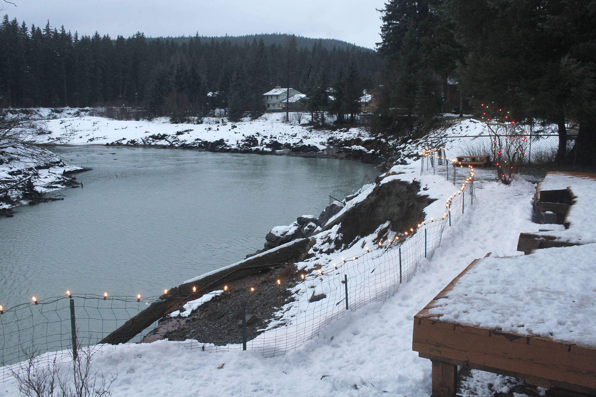 The view from the Staton residence on Meander Way shows the erosion caused by the Mendenhall River. The Statons are putting in a bank stabilization project after erosion has caused them to lose most of their backyard. They recently cut part of their deck off, seen in the lower right. (Alex McCarthy | Juneau Empire)