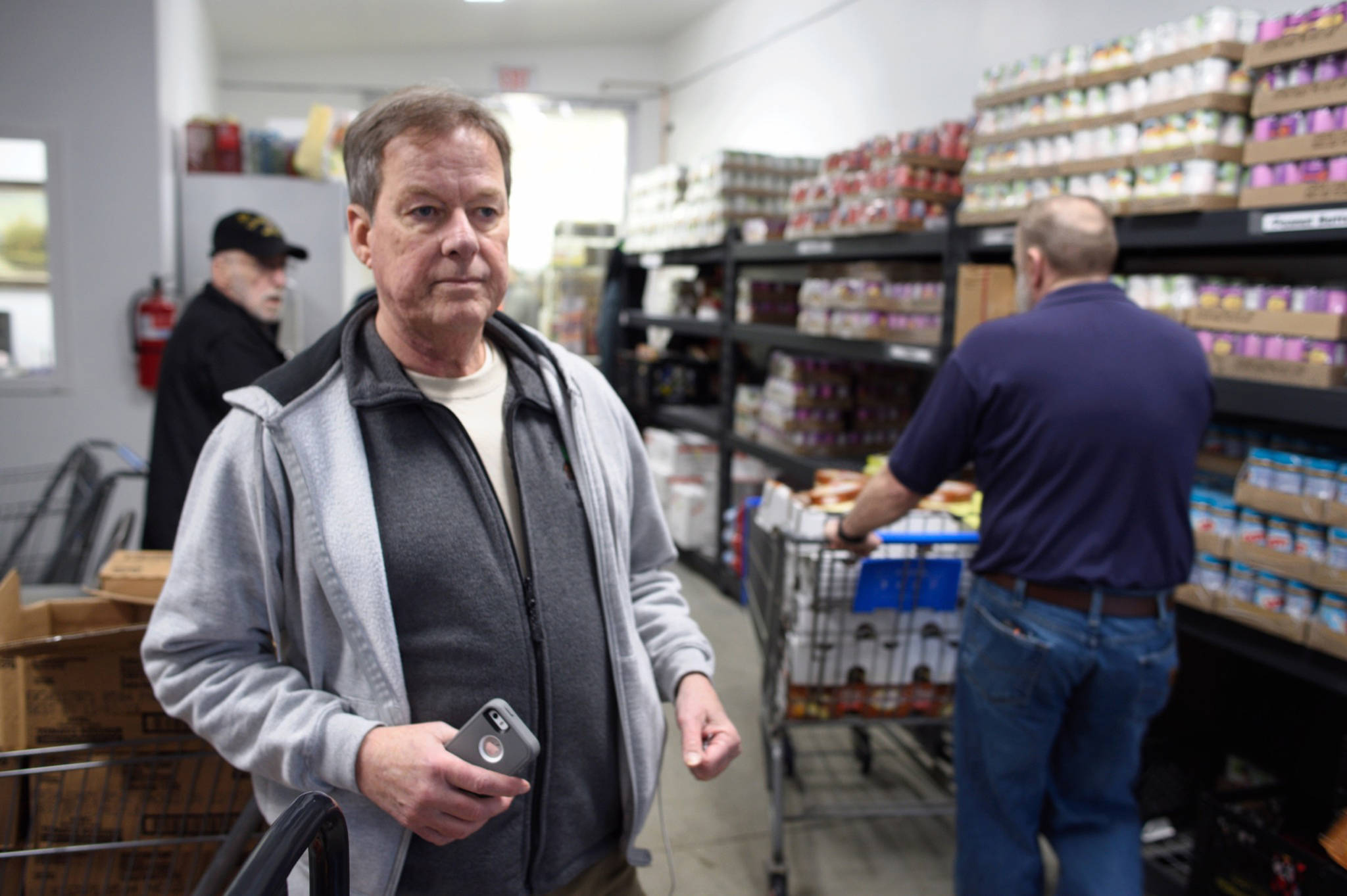 Eric Adam watches as food is distributed at the Southeast Alaska Food Bank on Monday, Jan 21, 2019. Adam works as an administrative assistant with the U.S. Forest Service. Adam has set up a Facebook page to help federal employees not currently receiving a paycheck because of the partial federal shutdown. (Michael Penn | Juneau Empire)