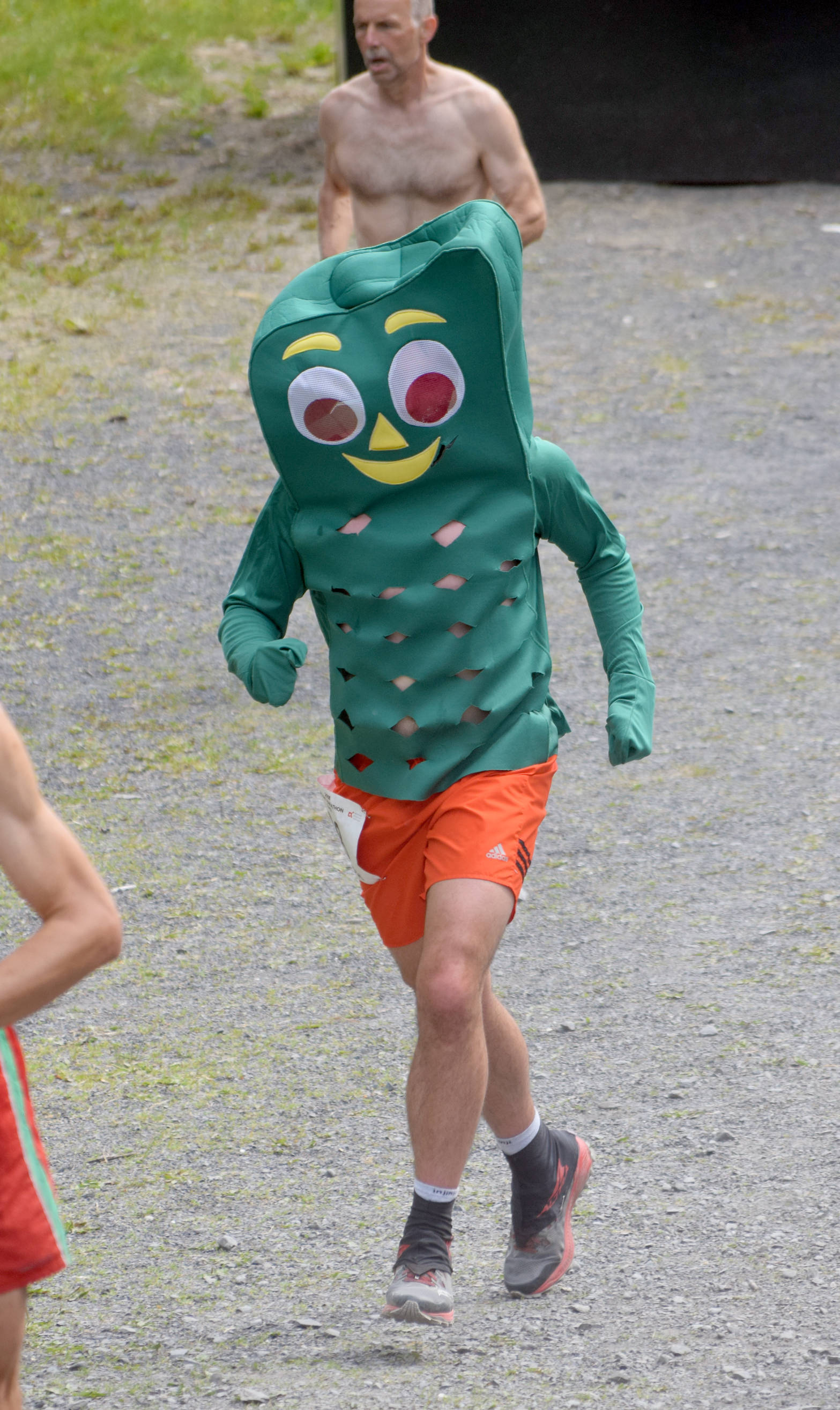 Joe Nyholm of Seward runs the Mount Marathon Race in a Gumby costume Wednesday, July 4, 2018, in Seward. (Photo by Jeff Helminiak/Peninsula Clarion)