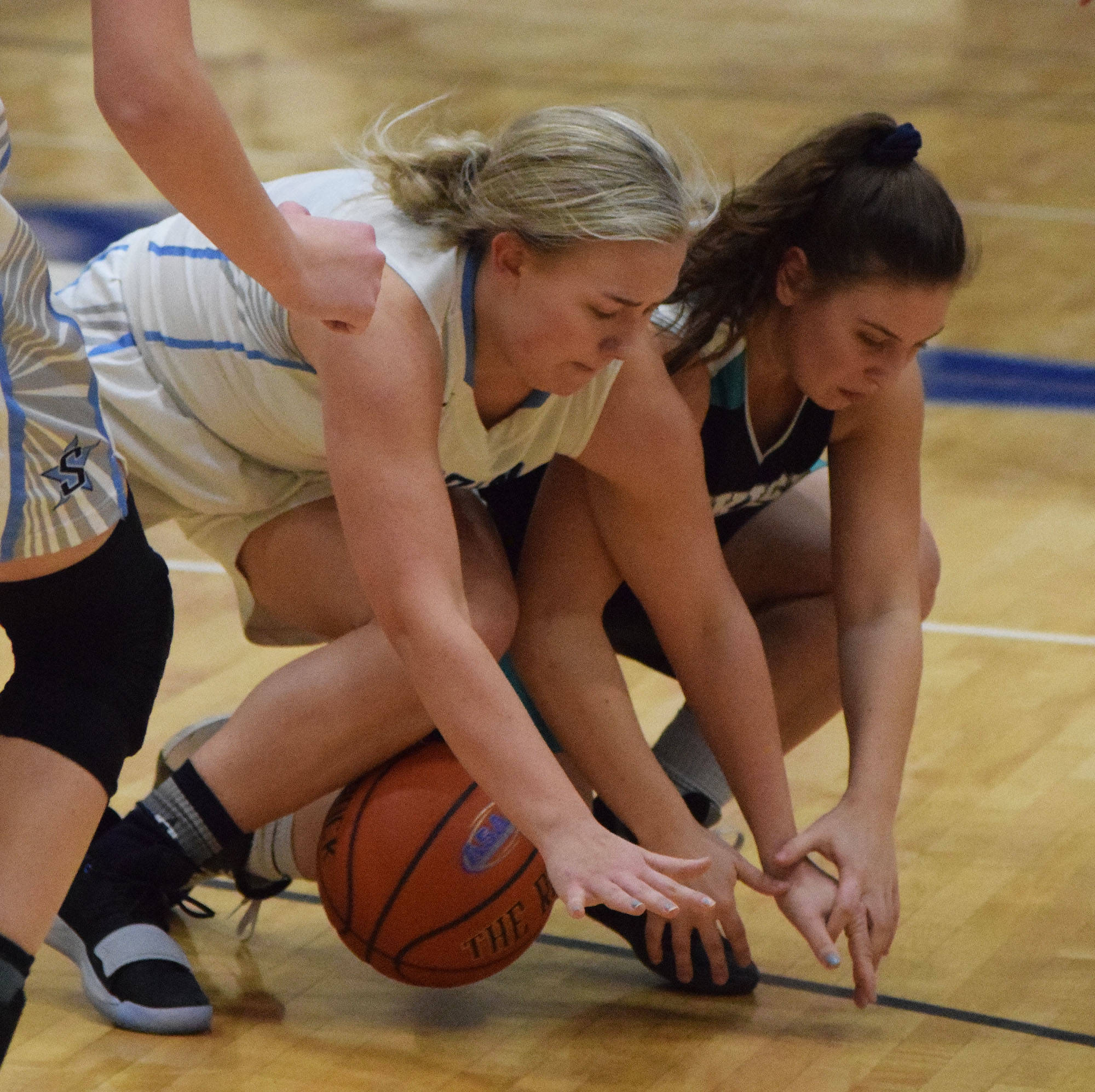 Soldotna’s Brittani Blossom (left) and Nikiski’s Kelsey Clark battle for the ball Tuesday night in a nonconference game at Soldotna High School. (Photo by Joey Klecka/Peninsula Carion)