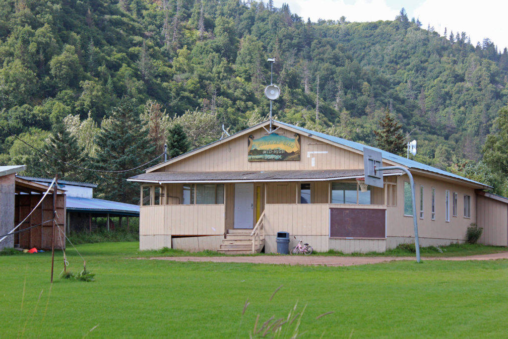 The Kachemak Selo Middle-High School building sits against a backdrop of the ridge separating the village from the Kenai Peninsula Borough road system on Aug. 30, 2018 in Kachemak Selo. (Photo by Megan Pacer/Homer News)