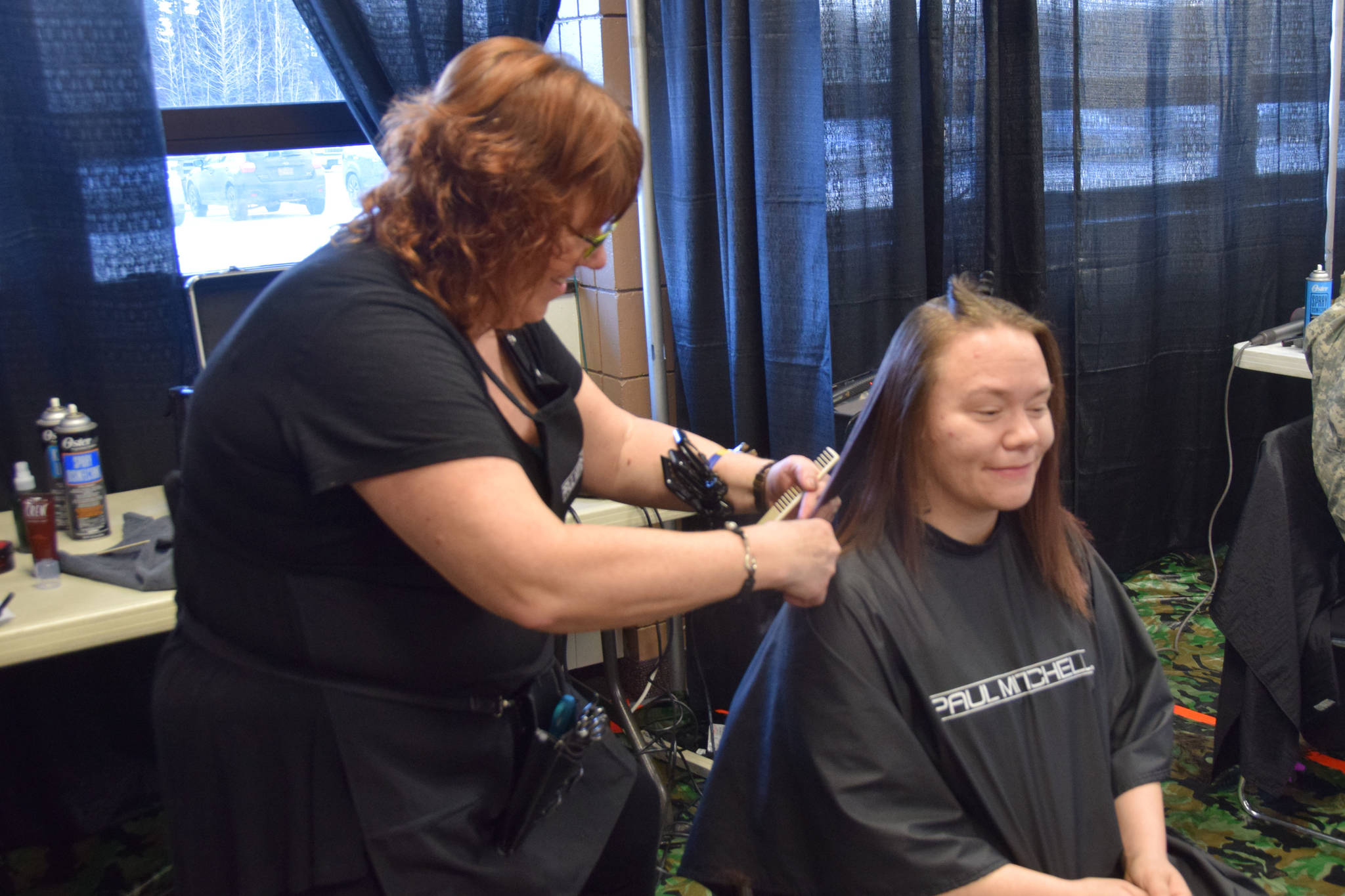 Peninsula resident Leanna enjoys a free hair cut during Project Homeless Connect at the Soldotna Regional Sports Complex on Wednesday, Jan. 23, 2019. (Photo by Brian Mazurek/Peninsula Clarion)