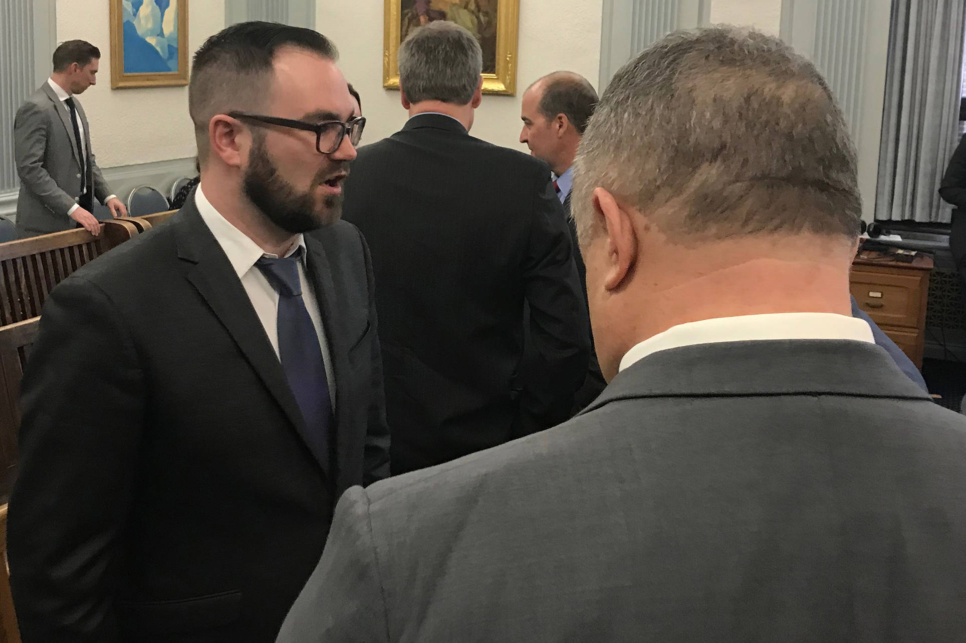 Department of Administration Commissioner Designee John Quick, left, speaks with senators after talking to the Senate Finance Committee on Tuesday, Jan. 22, 2019. (Alex McCarthy | Juneau Empire)