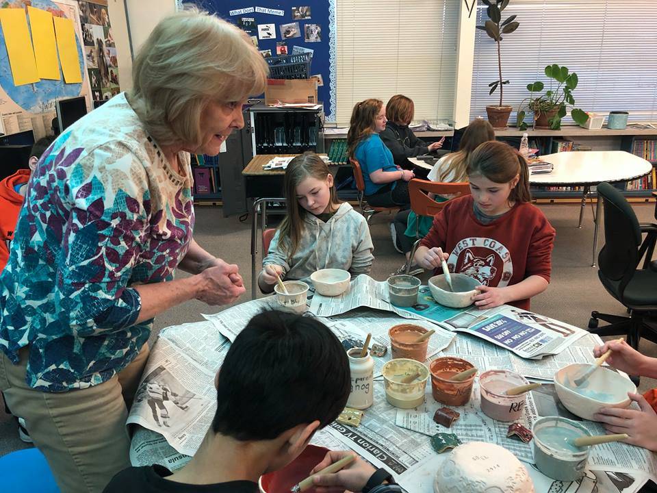 Debbie Adamson, president of the Kenai Potters Guild and former Soldotna Elementary School librarian, helps fifth-graders work on making their own ceramic bowls for a fundraiser that will buy new playground equipment for the school on Thursday, in Soldotna. (Photo by Victoria Petersen/Peninsula Clarion)