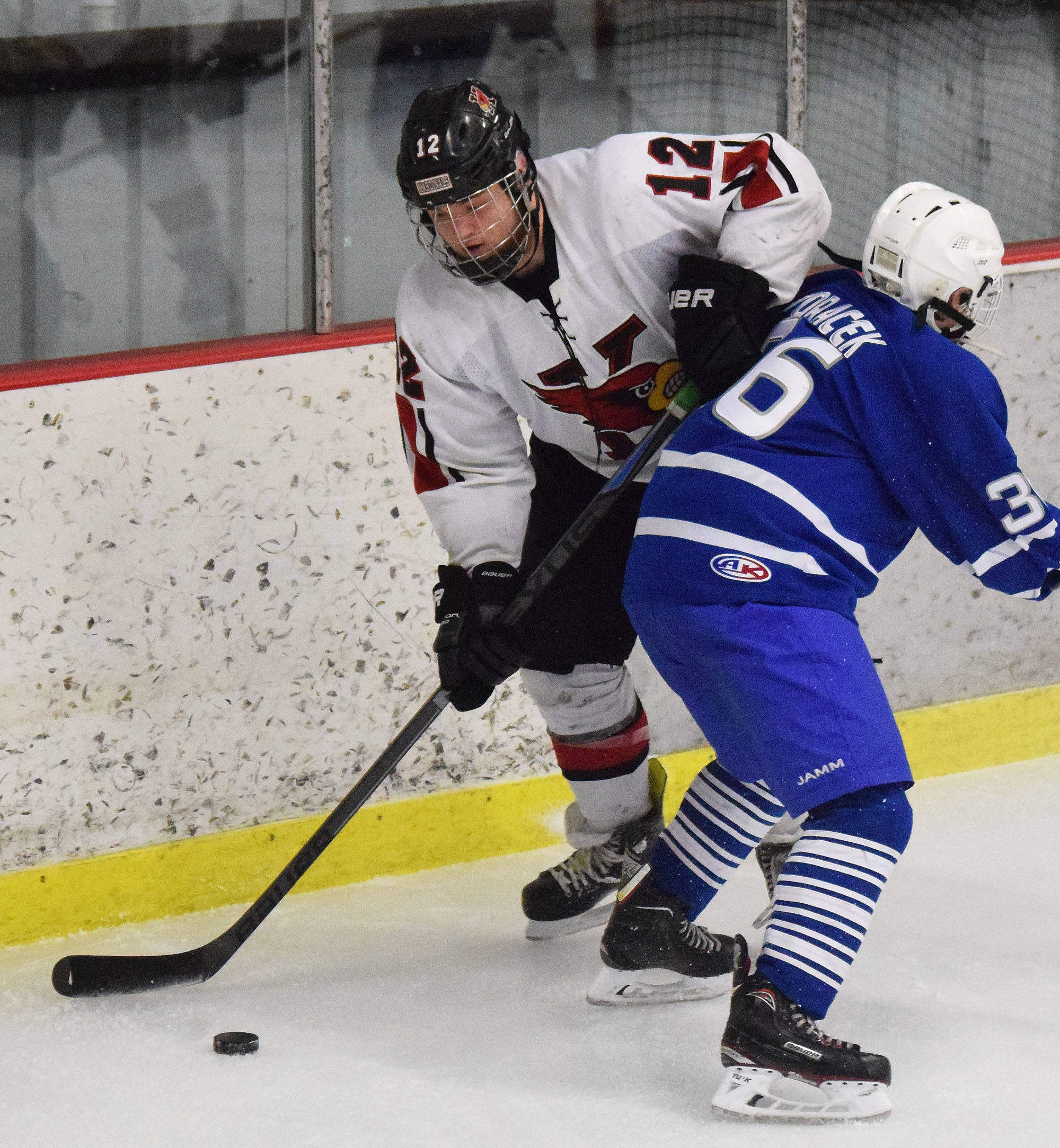 Kenai’s Bailey Maxson (left) steals the puck from Palmer’s Jeremy Horacek Friday night at the Kenai Multipurpose Facility. (Photo by Joey Klecka/Peninsula Clarion)