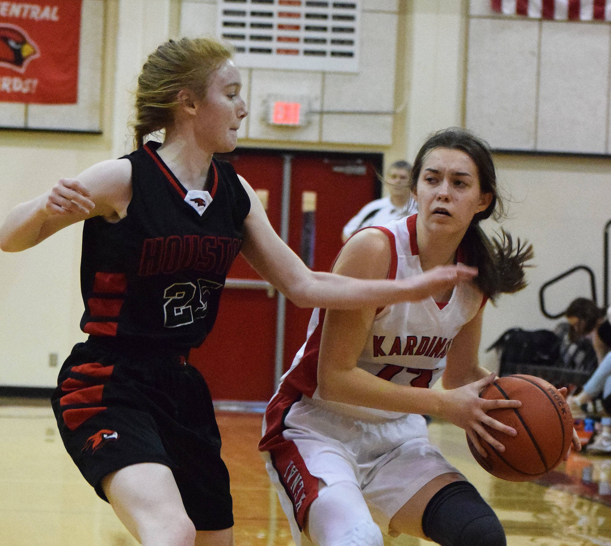 Kenai’s Logan Satathite dribbles to the arc against Houston’s Katie Ritchie Saturday afternoon at Kenai Central High School. (Photo by Joey Klecka/Peninsula Clarion)