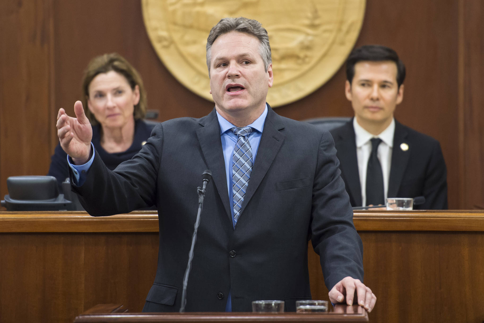 Gov. Mike Dunleavy give his State of the State speech to a Joint Session of the Alaska Legislature as Senate President Cathy Giessel, R-Anchorage, left, and House Speaker Pro Tempore Rep. Neal Foster, D-Nome, listen at the Capitol on Tuesday, Jan. 22. (Michael Penn/Juneau Empire)