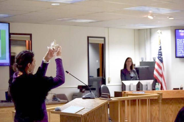 Community member Kalliste Edeen offers an invocation at the Tuesday, Jan. 8, 2019, Kenai Peninsula Borough Assembly meeting. The borough recently lost a lawsuit over its invocation policy, and has been ordered to pay legal fees for the ACLU. (Photo by Brian Mazurek/Peninsula Clarion)
