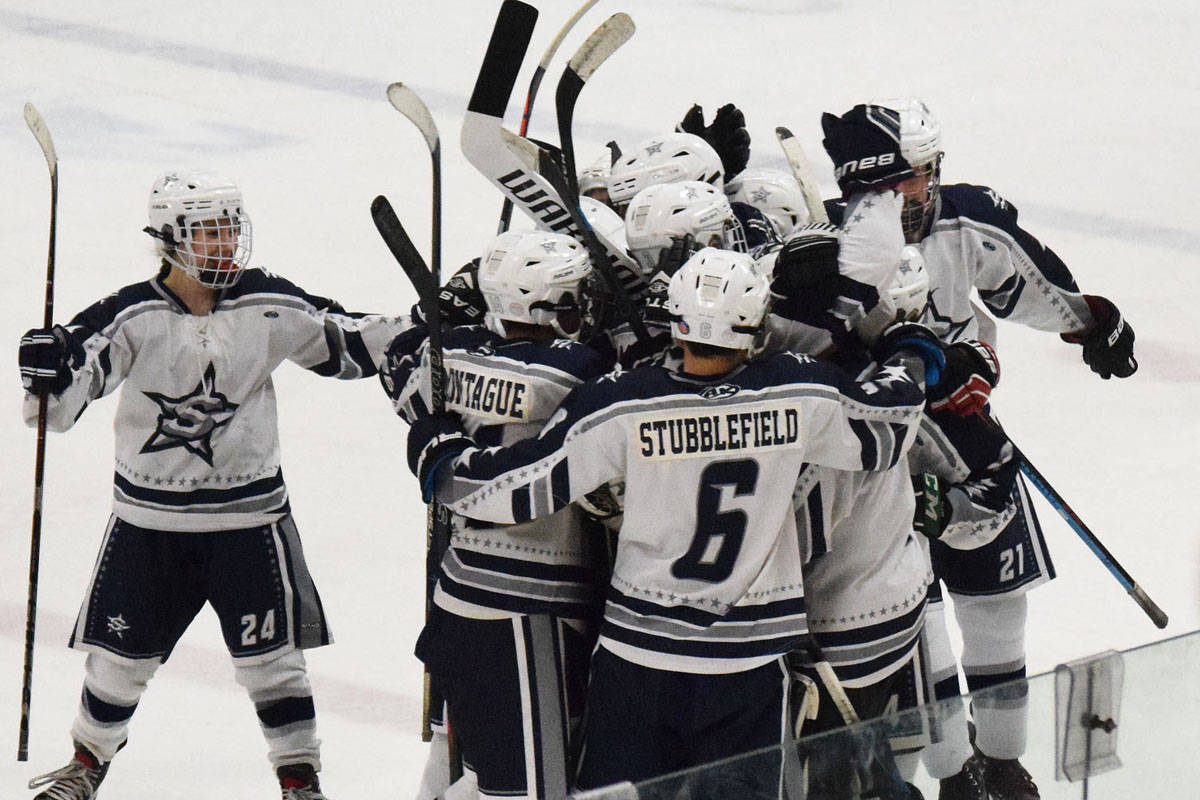 The Soldotna hockey team celebrates Galen Brantley III’s game-winning goal in overtime over the Palmer Moose that clinched the top seed for SoHi in the upcoming Div. II state hockey tournament. (Photo by Joey Klecka/Peninsula Clarion)