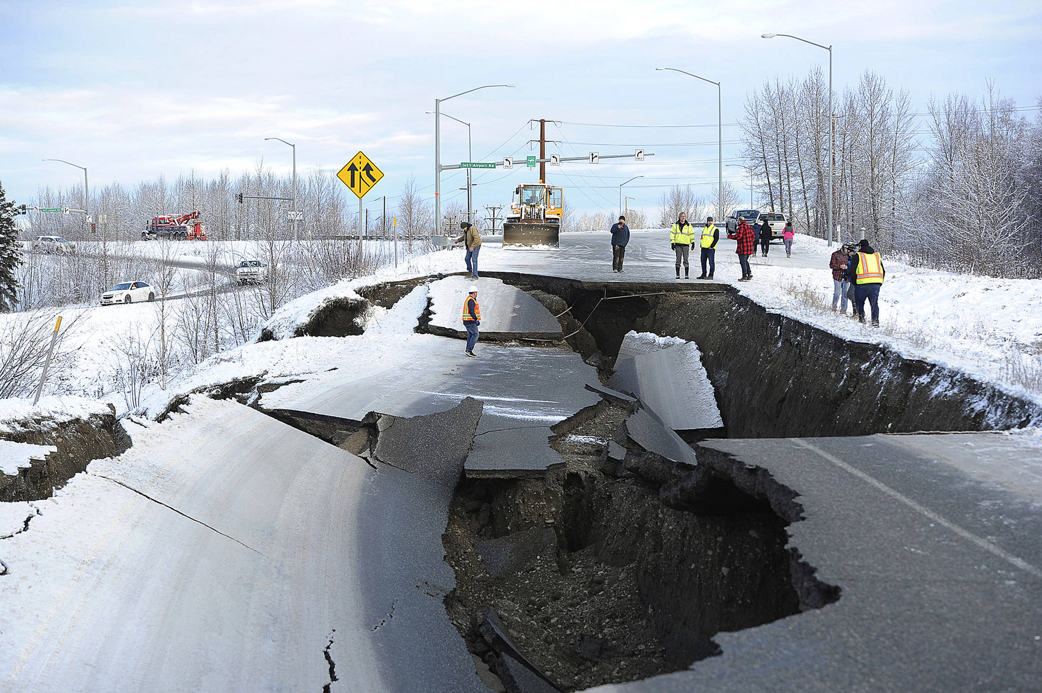 In this Nov. 30, 2018, file photo, workers inspect an off-ramp that collapsed during a morning earthquake in Anchorage. (AP Photo/Mike Dinneen, File)