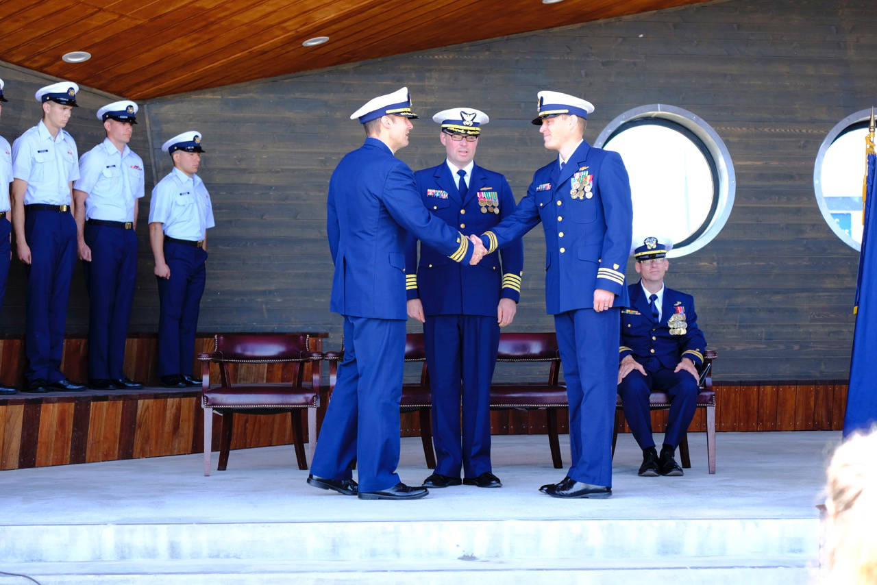 At a change of command ceremony on July 18, 2018 command of the USCGC Hickory is handed from Commander Andrew Passic (left) to Lt. Commander Adam Legget (second to right) at the Homer Boat House in Homer, Alaska. Overseeing the change of command is Capt. Patrick Hilbert (second to left) and Chaplain Lt. Gary Pepper (right). The ceremony took place in the new Homer Boat House at the Homer Harbor. (Photo by PO2 Andrew Keenan, Marine Safety Detachment Homer, United States Coast Guard)                                At a change of command ceremony on July 18, 2018 command of the USCGC Hickory is handed from Commander Andrew Passic (left) to Lt. Commander Adam Legget (second to right) at the Homer Boat House in Homer, Alaska. Overseeing the change of command is Capt. Patrick Hilbert (second to left) and Chaplain Lt. Gary Pepper (right). The ceremony took place in the new Homer Boat House at the Homer Harbor. (Photo by PO2 Andrew Keenan, Marine Safety Detachment Homer, United States Coast Guard)