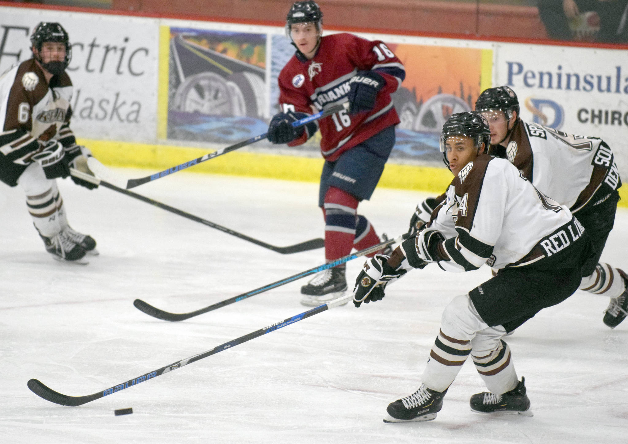 Kenai River Brown Bears defenseman Ryan Reid controls the puck Sunday, Nov. 25, 2018, against the Fairbanks Ice Dogs at the Soldotna Regional Sports Complex. (Photo by Jeff Helminiak/Peninsula Clarion)