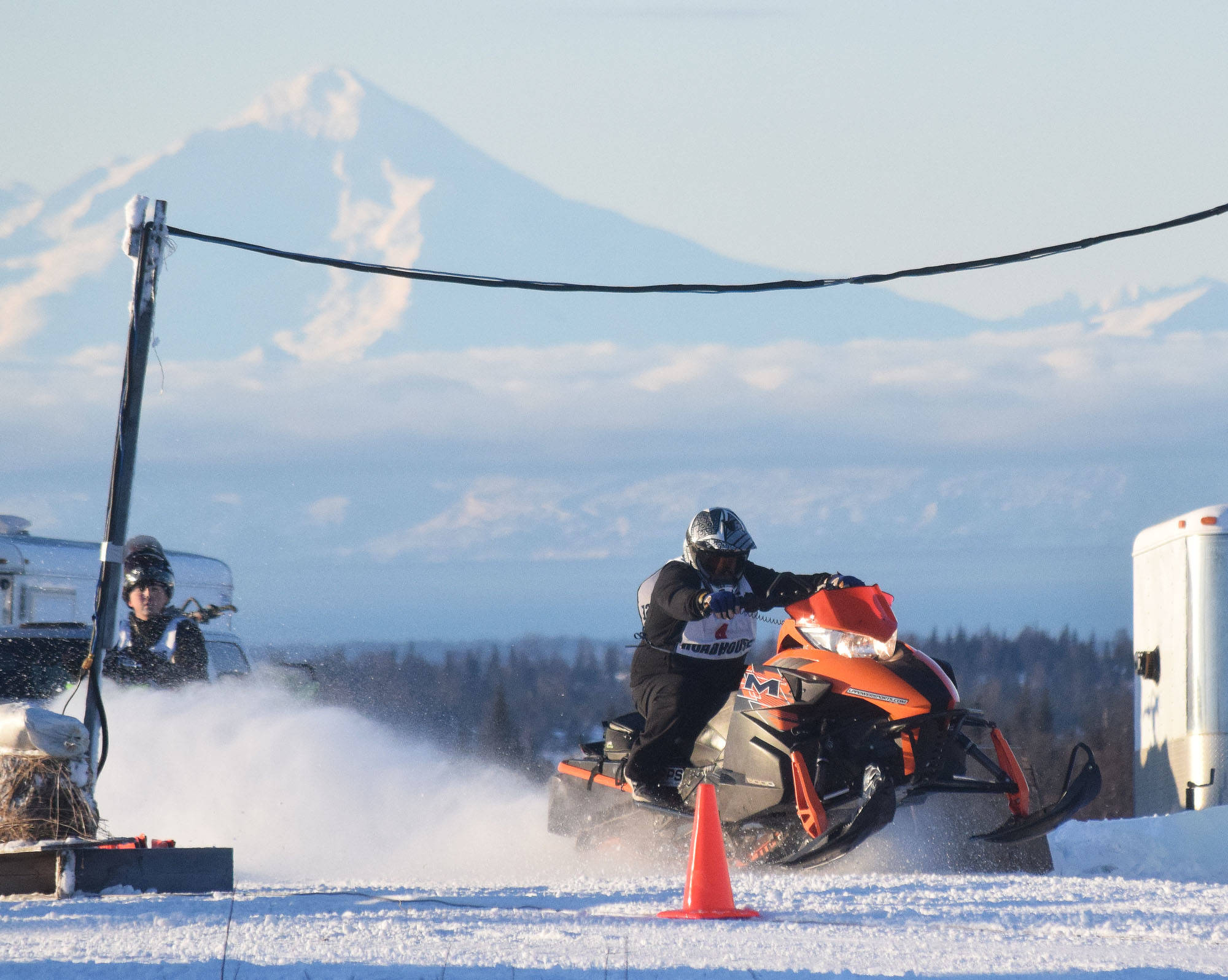 George Derkevorkian takes off at the start of a drag heat Saturday afternoon at the snowmachine drag races at Freddie’s Roadhouse near Ninilchik. (Photo by Joey Klecka/Peninsula Clarion)