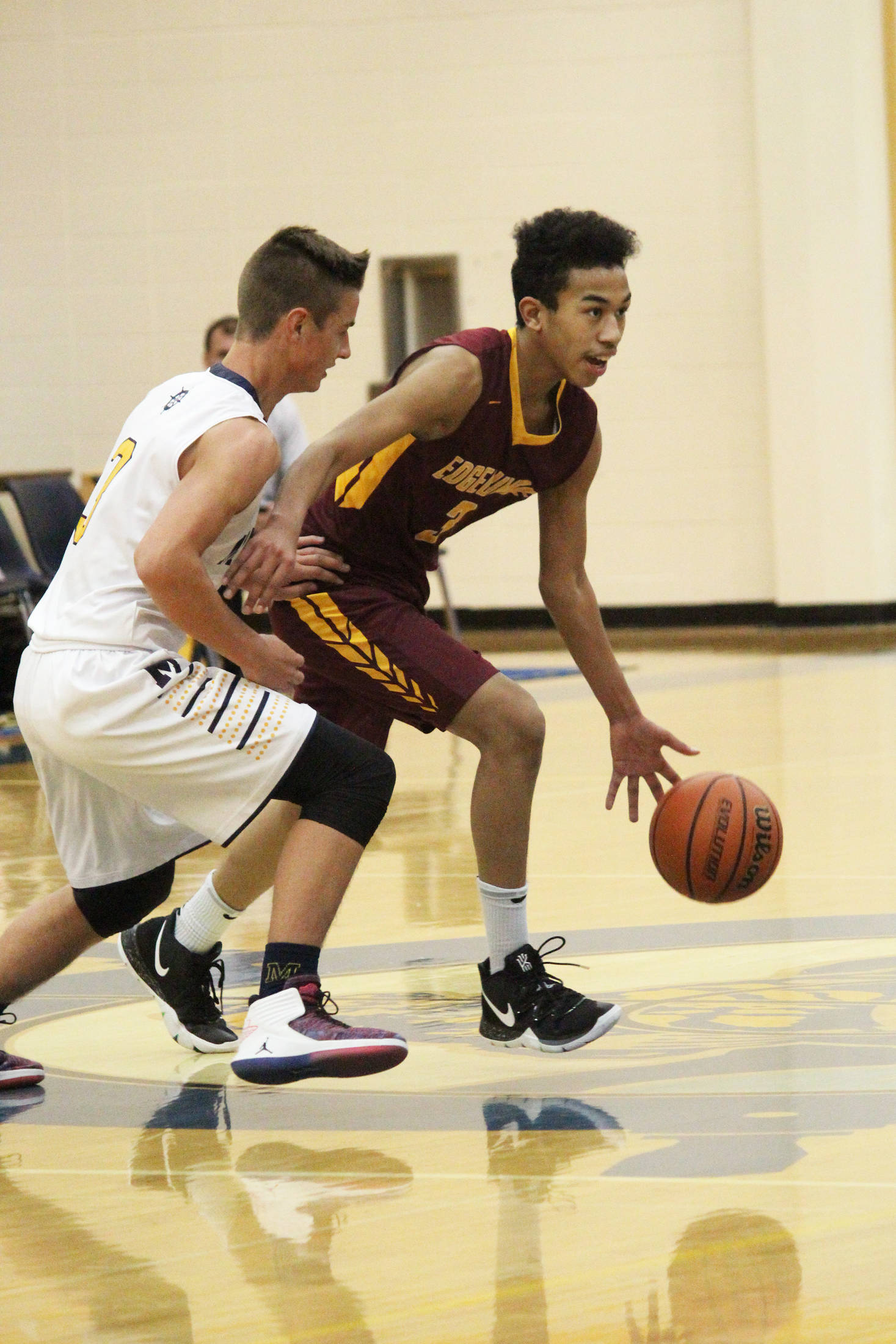 Mt. Edgecumbe’s Leon Toomer looks for a place to go under pressure from Homer’s Clayton Beachy during a Thursday, Jan. 10, 2019 game in Homer, Alaska. (Photo by Megan Pacer/Homer News)