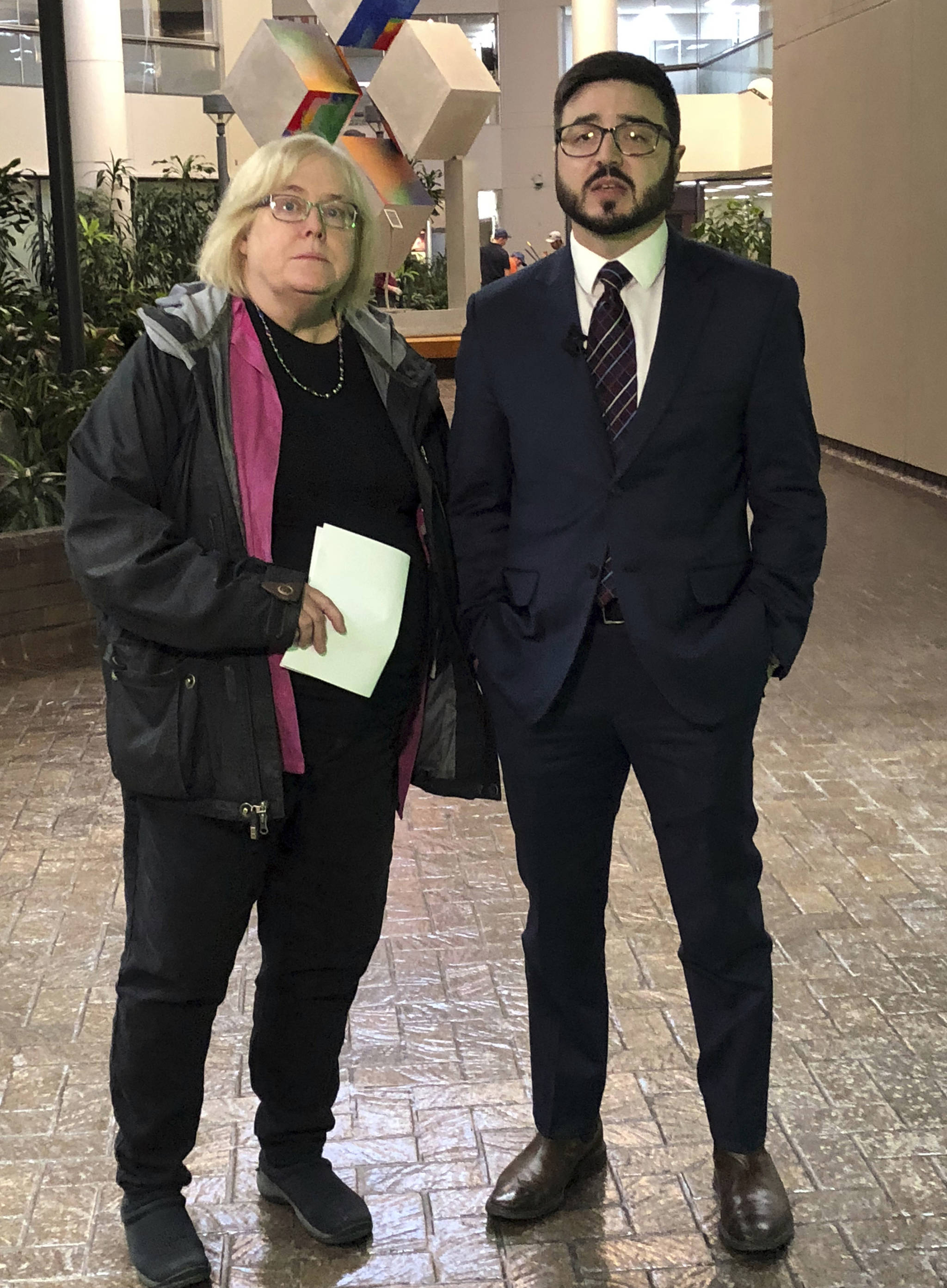 Deitra Ennis, left, and Ryan Stuart, attorneys with the city of Anchorage, Alaska, talk to reporters after a hearing in federal court Friday, Jan. 11, 2019. They represent the city in a federal lawsuit filed by a faith-based shelter over a local requirement that it accept transgender women. Alliance Defending Freedom, a conservative Christian law firm, is seeking a temporary injunction to stop the city from applying its gender identity law to the Hope Center shelter. (AP Photo/Rachel D’Oro)