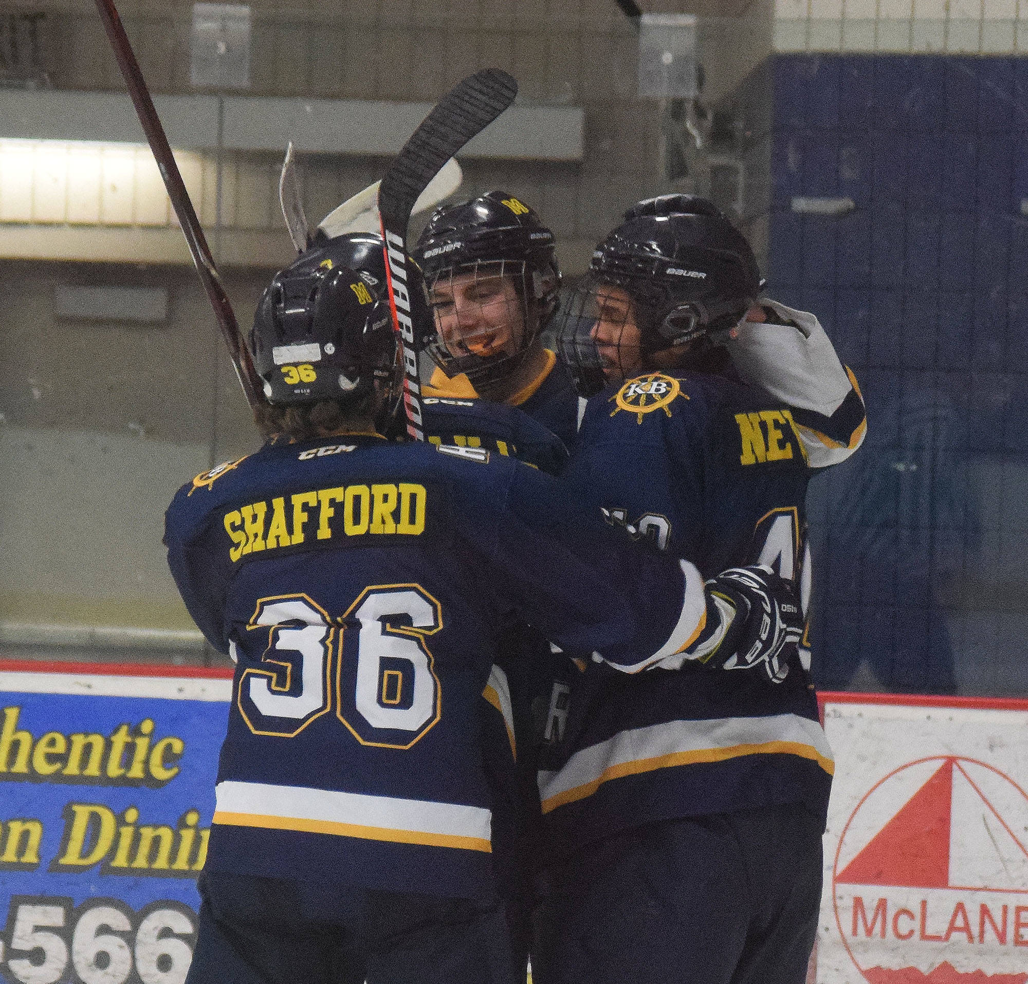 Homer skater Tyler Gilliland (center) celebrates with teammates after scoring a goal in the second period Tuesday night against Soldotna at the Soldotna Regional Sports Complex. (Photo by Joey Klecka/Peninsula Clarion)