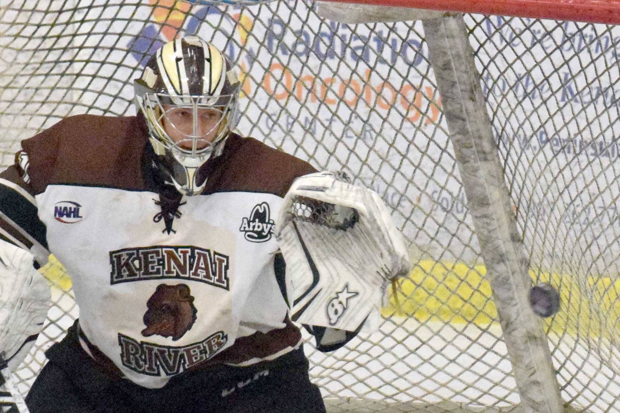 Kenai River Brown Bears goalie Gavin Enright tracks the puck for a save as defenseman Connor Scahill looks on Friday, Nov. 3, 2018, at the Soldotna Regional Sports Complex. (Photo by Jeff Helminiak/Peninsula Clarion)
