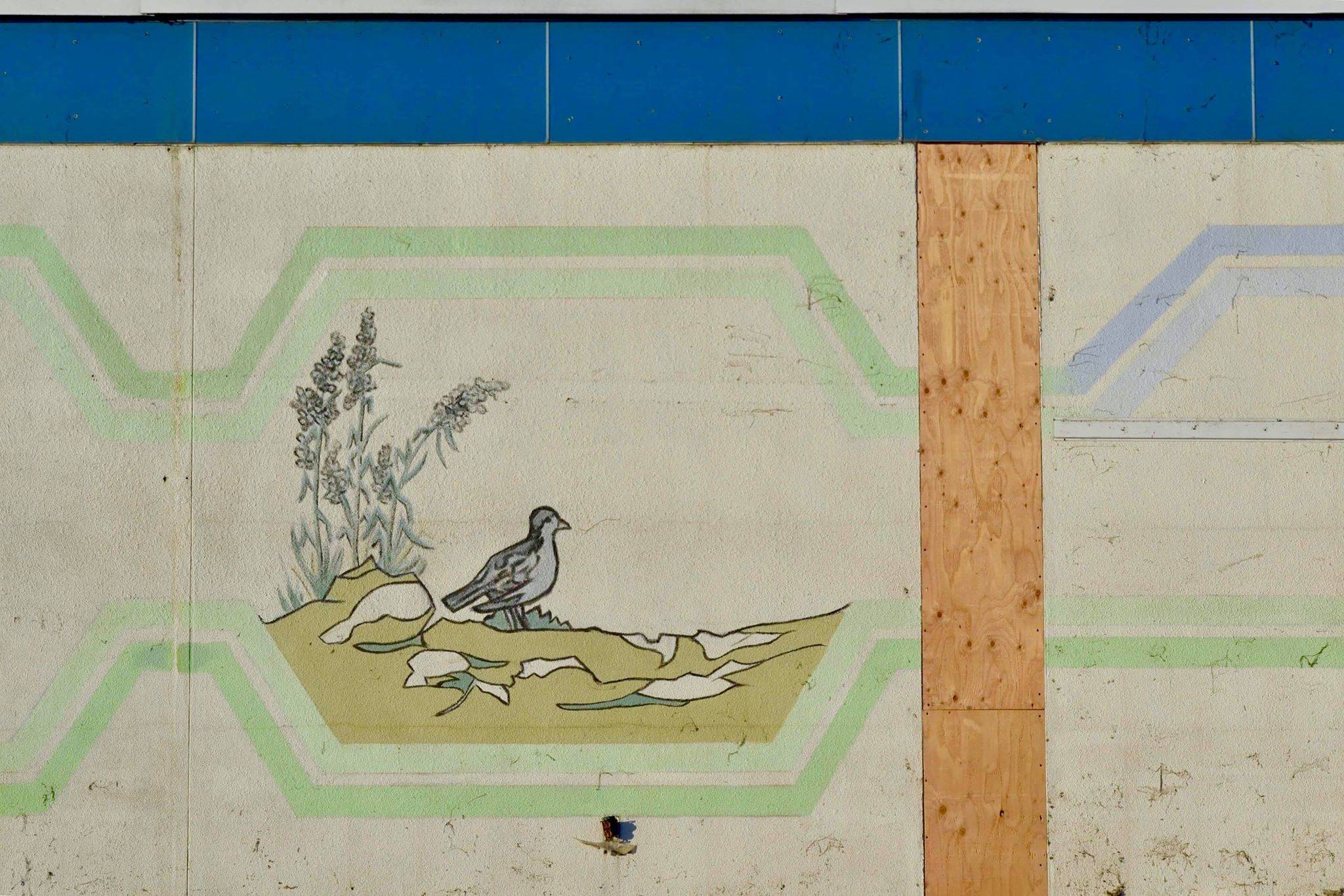After construction workers removed siding from the facade of the Kenai Municipal Airport, a mural with iconic Kenai images like fishing nets, the St. Nicholas Russian Orthodox chapel and a dog musher, was revealed on Tuesday, Jan. 15, 2019 in Kenai, Alaska. (Photo by Victoria Petersen/Peninsula Clarion)