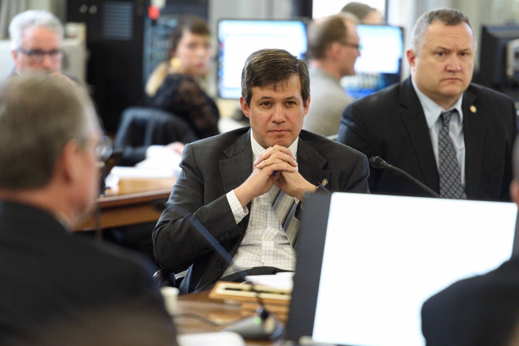 Sen. Bill Wielechowski, R-Anchorage, center, and Sen. Mike Shower, R-Wasilla, right, listen members from the Department of Revenue give a state revenue forecast during a Senate Finance Committee meeting at the Capitol on Wednesday, Jan. 16, 2019. (Michael Penn | Juneau Empire)