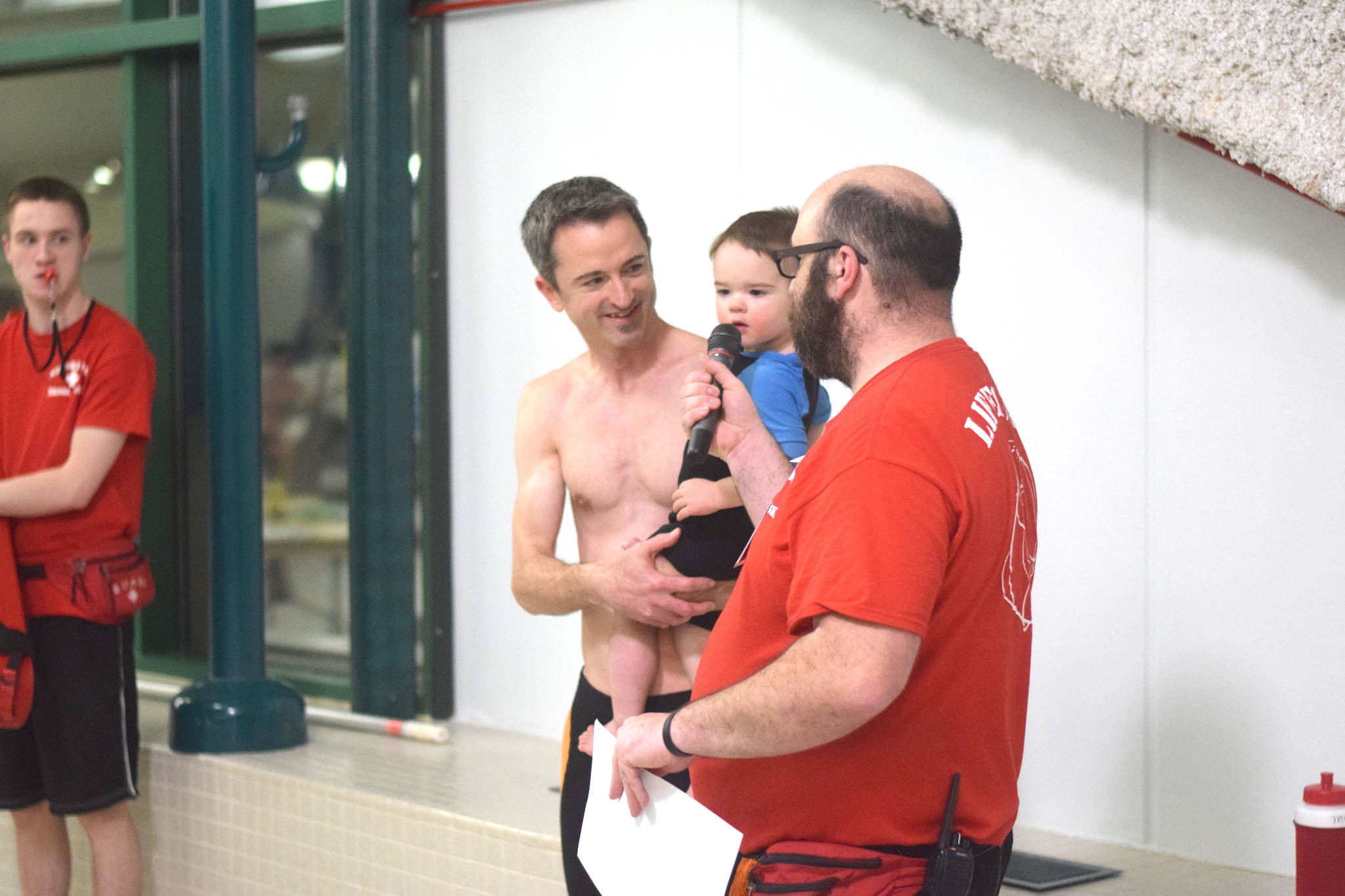 Pool supervisor Nigel LaRiccia announces the start of the cannonball contest at the Nikiski Pool with help from a friend on Thursday, Jan. 17, 2019. (Photo by Brian Mazurek/Peninsula Clarion)