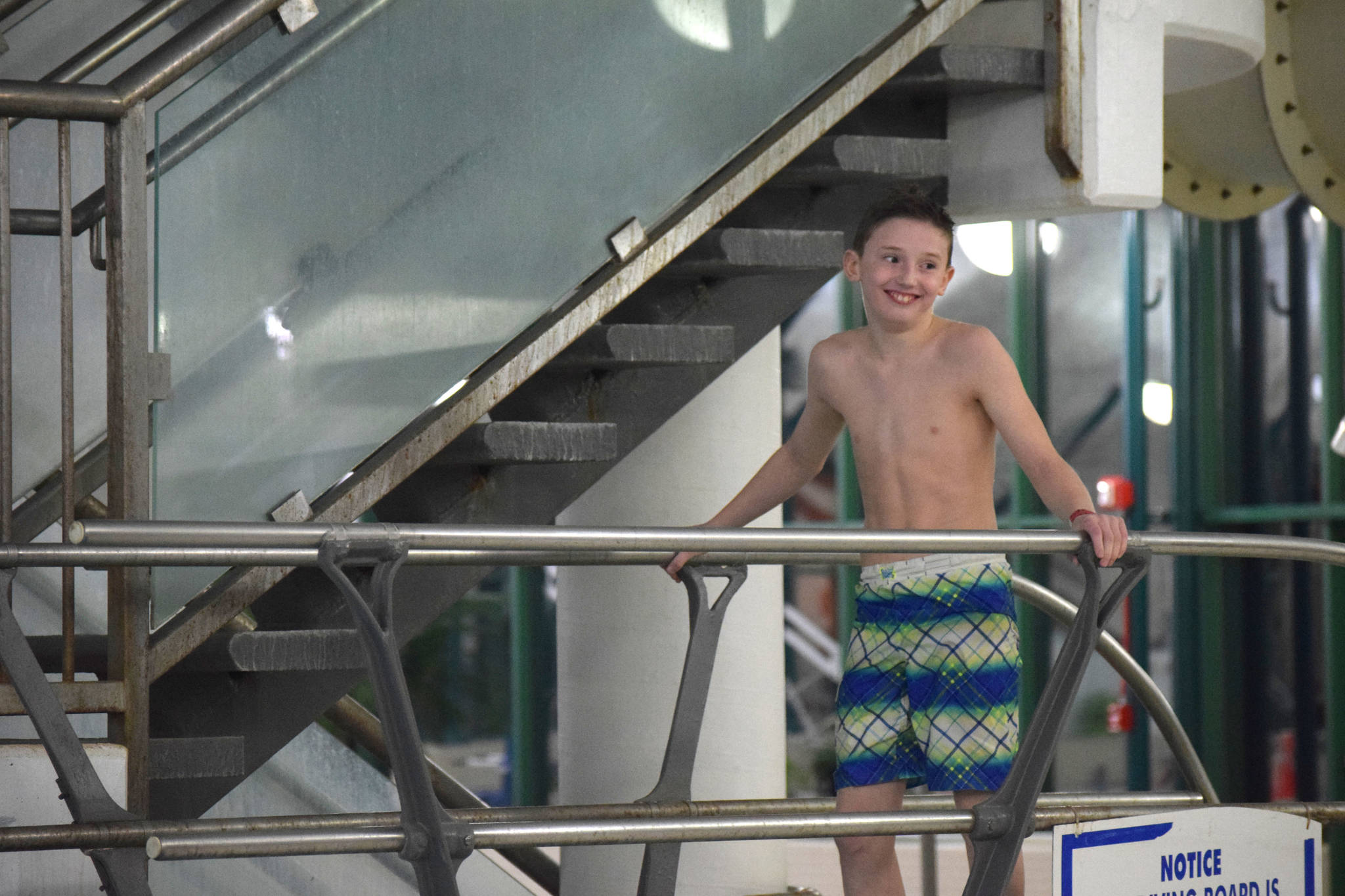 A contestant in the cannonball contest at the Nikiski Pool smiles for the judges on Thursday, Jan. 17, 2019. (Photo by Brian Mazurek/Peninsula Clarion)