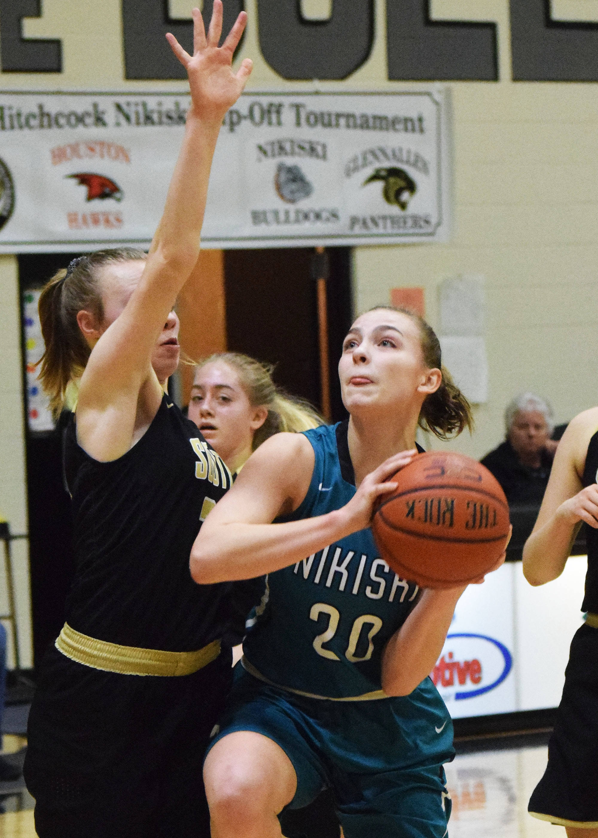 Nikiski’s Bethany Carstens (20) looks for a shot against South’s Maris Soland Saturday at the Rus Hitchcock Nikiski Tip Off tournament. (Photo by Joey Klecka/Peninsula Clario¡n)