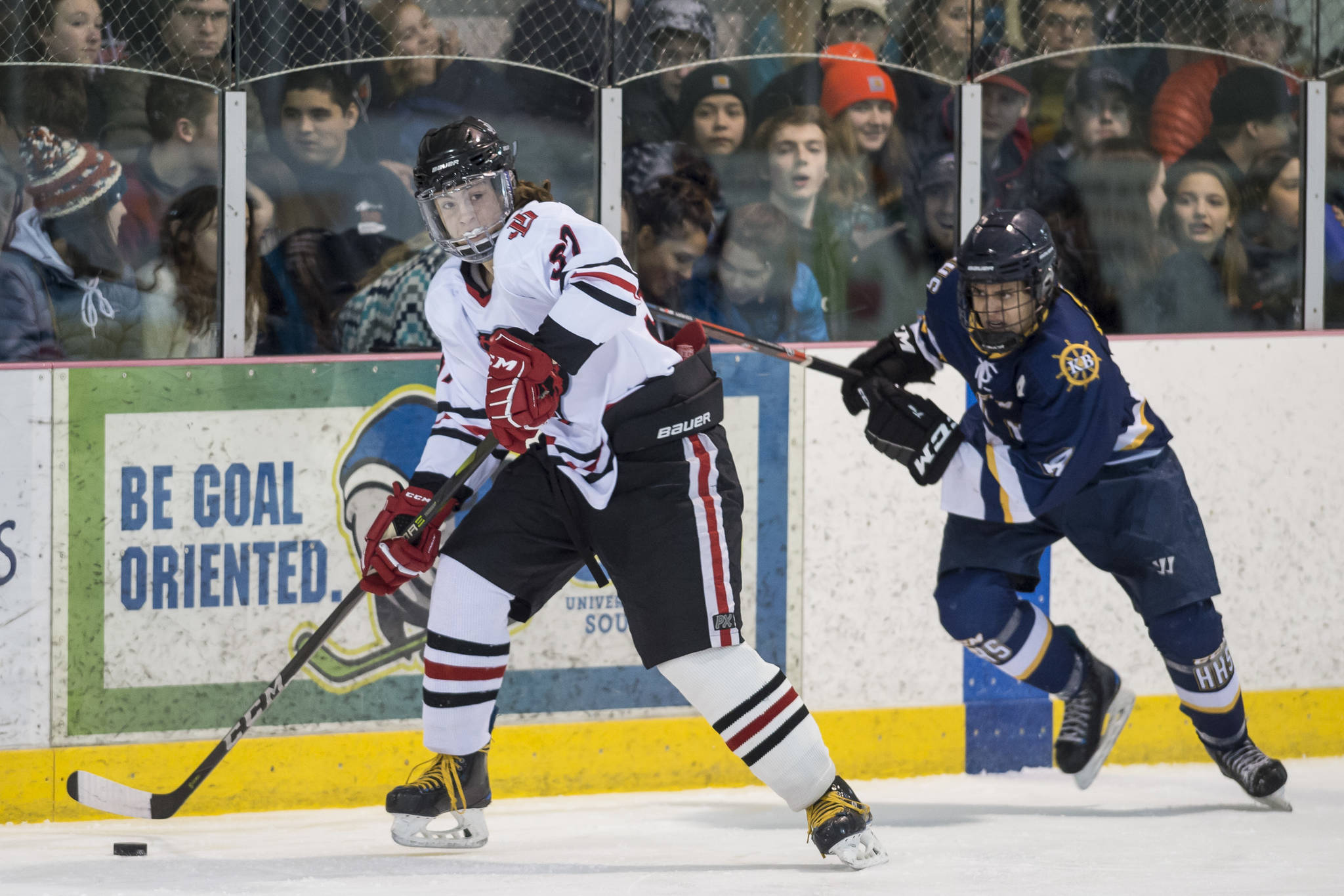 Juneau-Douglas’ Chance Turinsky, left, drives past Homer’s Isaiah Nevak at Treadwell Arena on Friday, Jan. 18, 2019. JDHS won 4-3 in overtime. (Michael Penn | Juneau Empire)