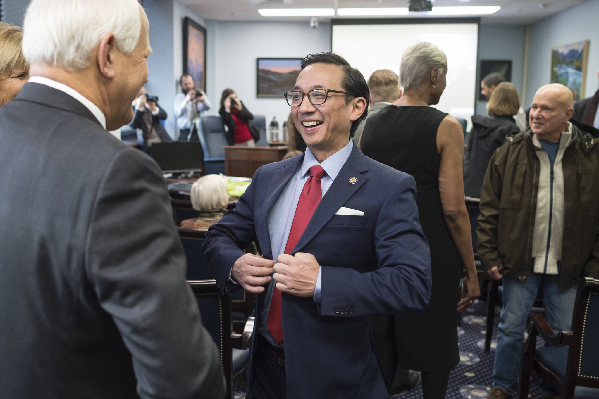 Sen. Scott Kawasaki, D-Fairbanks, gathers with other senators and families as they prepare for the opening of the Alaska’s 31st Legislative Session on Tuesday. (Michael Penn/Juneau Empire)