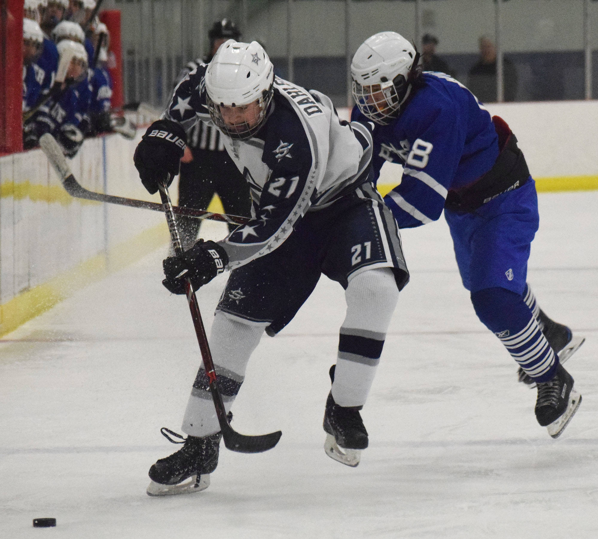 Soldotna’s Dylan Dahlgren (21) keeps the puck away from Palmer’s Shiloh Marinelli Friday in a state semifinal contest at the Curtis Menard Sports Complex in Wasilla. (Photo by Joey Klecka/Peninsula Clarion)