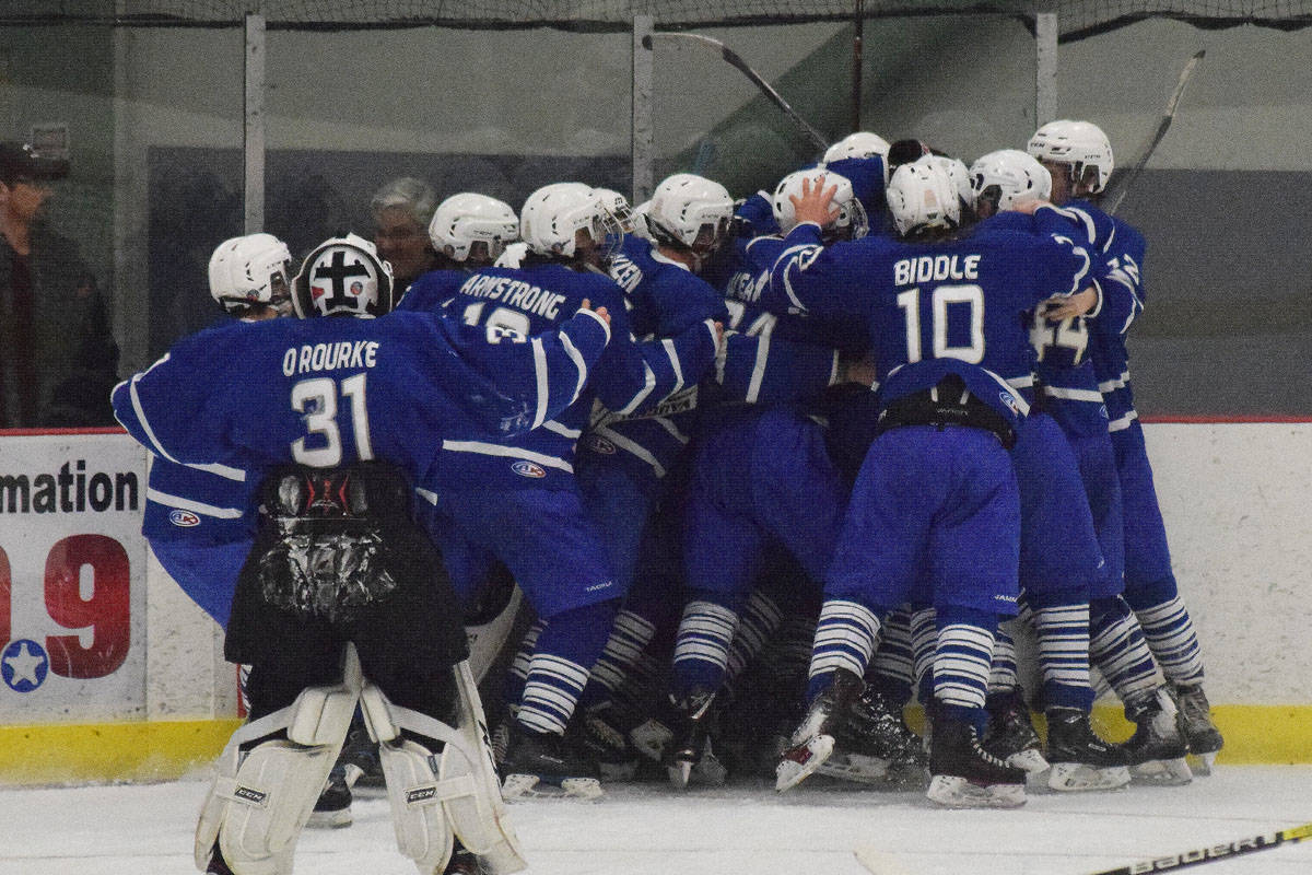 Members of the Palmer hockey team celebrate Friday after beating Soldotna in overtime in a state semifinal contest at the Curtis Menard Sports Complex in Wasilla. (Photo by Joey Klecka/Peninsula Clarion)