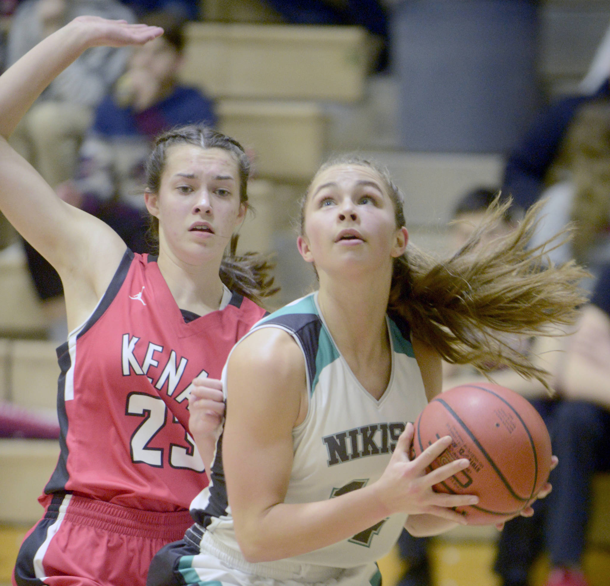 Nikiski’s Kaitlyn Johnson goes up for a shot against Kenai Central’s Logan Satathite on Friday, Feb. 1, 2019, at Nikiski High School. (Photo by Jeff Helminiak/Peninsula Clarion)