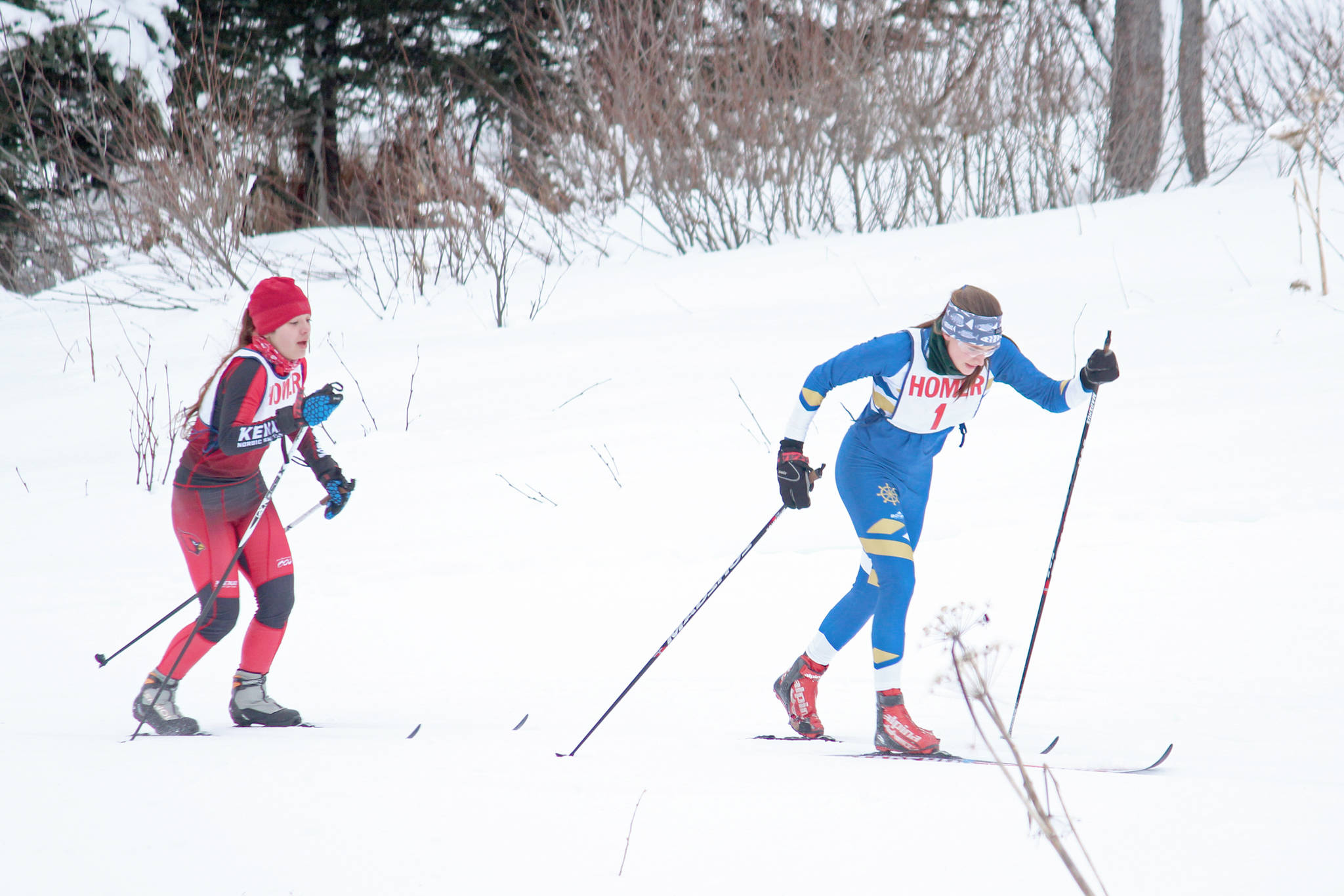 Homer’s Autumn Daigle pulls ahead of Kenai’s Maria Salzetti during the varsity girls’ classic cross-country ski race Friday, Feb. 1, 2019 at the Lookout Mountain Trails near Homer, Alaska. Salzetti had maintained the lead for the first portion of the race, and the two skiers battled for first througout. (Photo by Megan Pacer/Homer News)