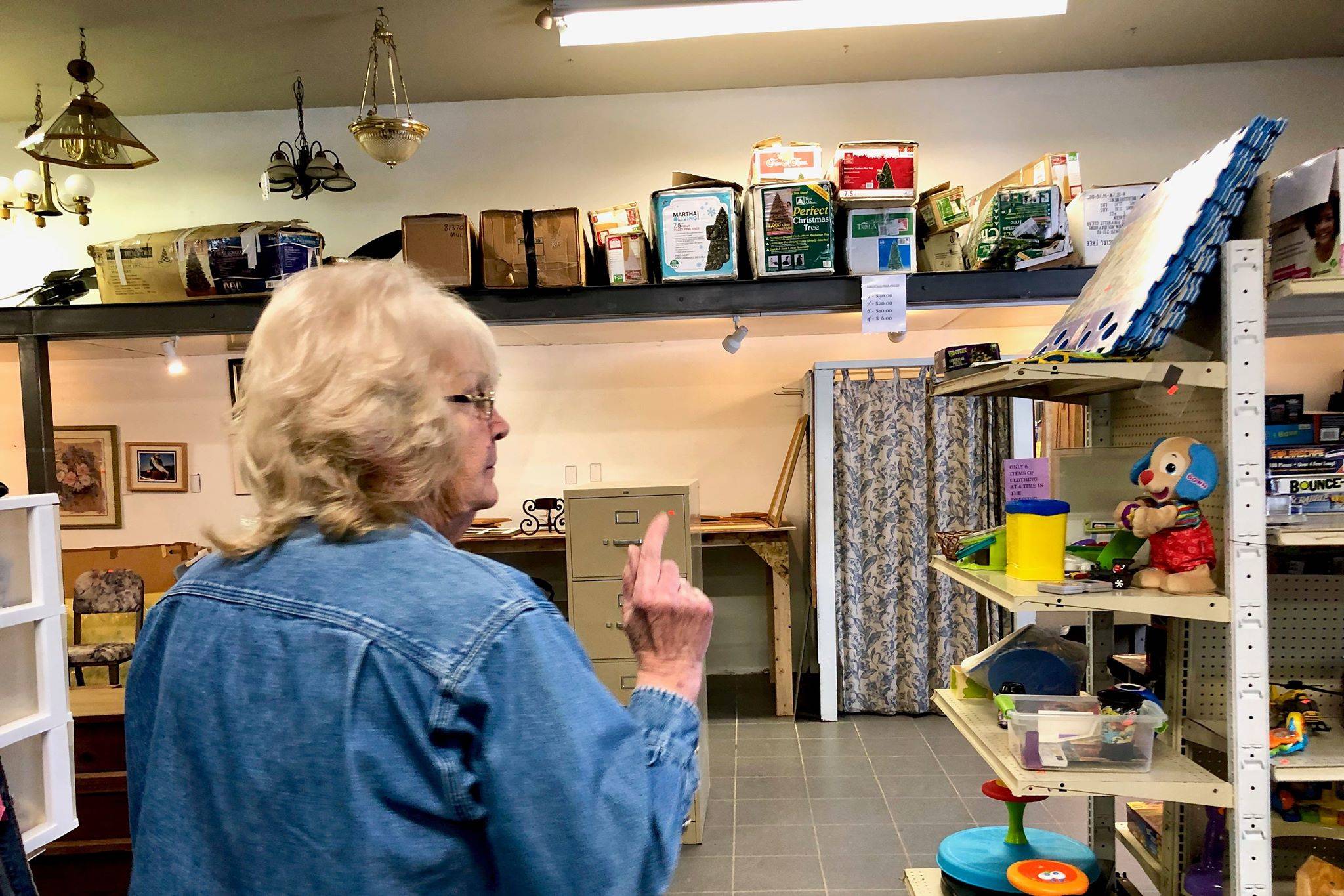 Manager of Bishop’s Attic in Soldotna, Alaska, Jean Warrick, walks around the thrift store where residents can find just about anything in the shop’s many aisles and shelves, on Friday, Feb. 1, 2019. (Photo by Victoria Petersen/Peninsula Clarion)