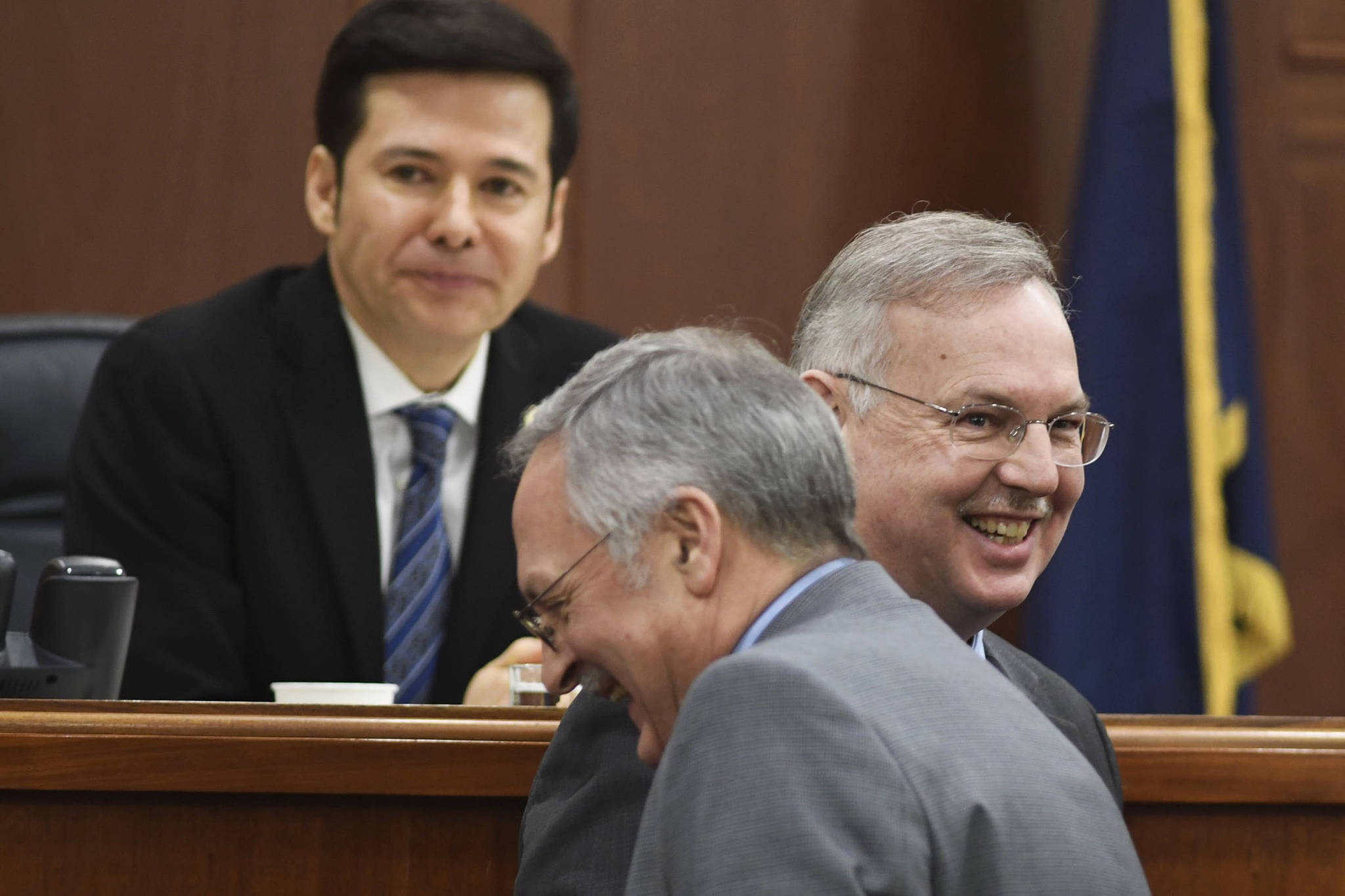 Former Speaker of the House Rep. Bryce Edgmon, D-Dillingham, right, shares a laugh with Speaker nominee Rep. David Talerico, R-Healy, at Speaker Pro Tempore Rep. Neal Foster, Nome, resides over the House on Monday. The House continues in a stalemate to organize permanent leadership. (Michael Penn | Juneau Empire)