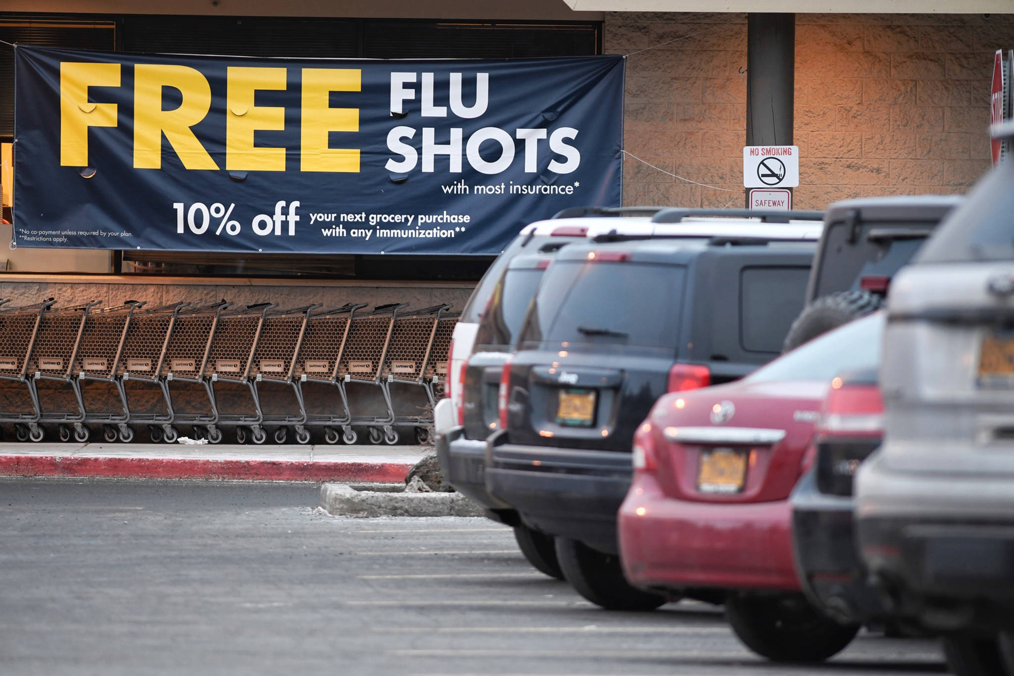 A sign outside Safeway advertises free flu shots, Feb. 5, 2019. (Michael Penn | Juneau Empire)