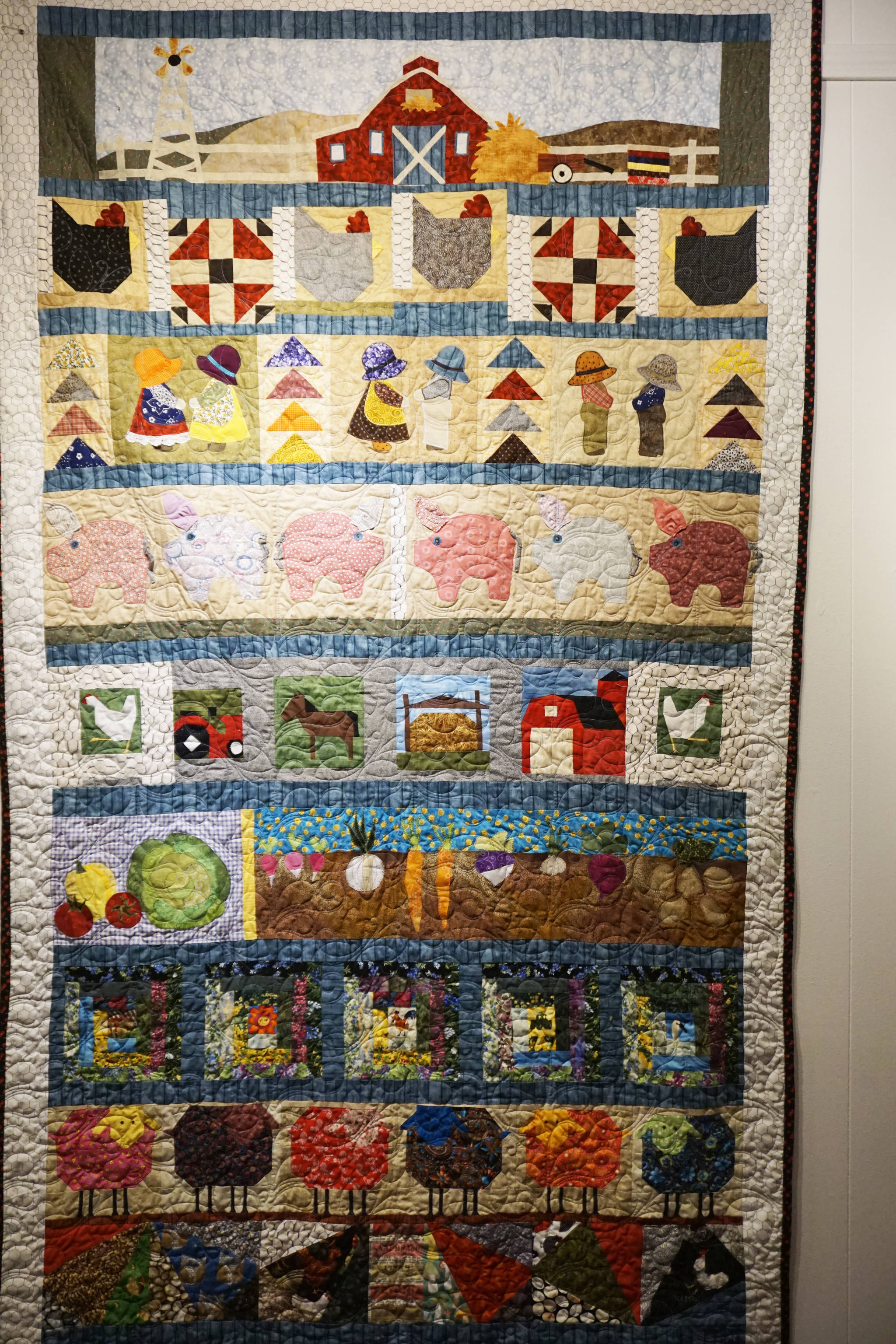 Karol Miller’s “Down on the Farm” quilt, one of the works in the “9 Women / 9 Quilts” show that opened last Friday, Feb. 1, 2019, at the Homer Council on the Arts, in Homer, Alaska. (Photo by Michael Armstrong/Homer News)