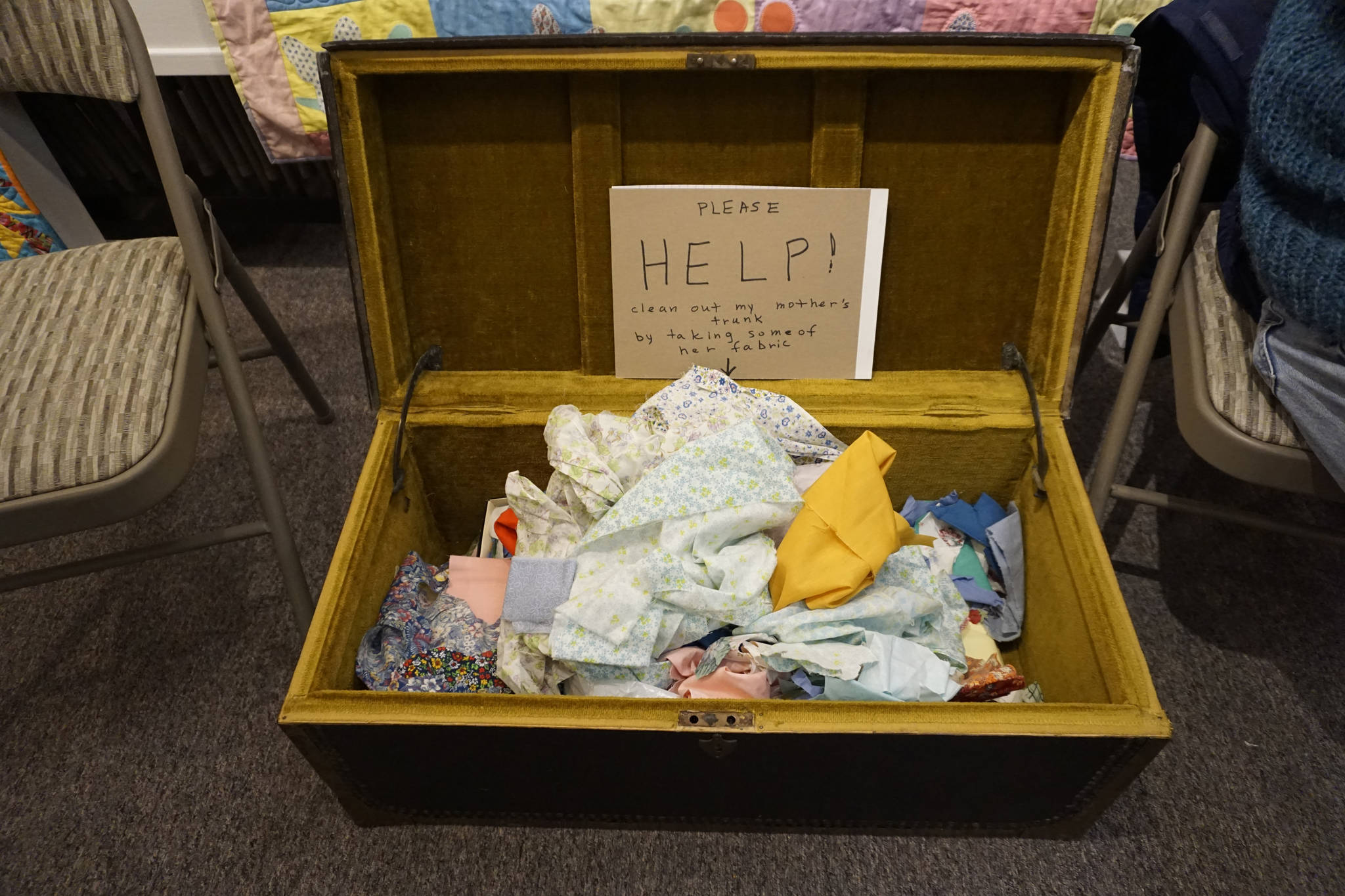 Quilter Jane Regan offered scraps of fabric from her mother’s collection at the “9 Women / 9 Quilts” show that opened last Friday, Feb. 1, 2019, at the Homer Council on the Arts, in Homer, Alaska. (Photo by Michael Armstrong/Homer News)