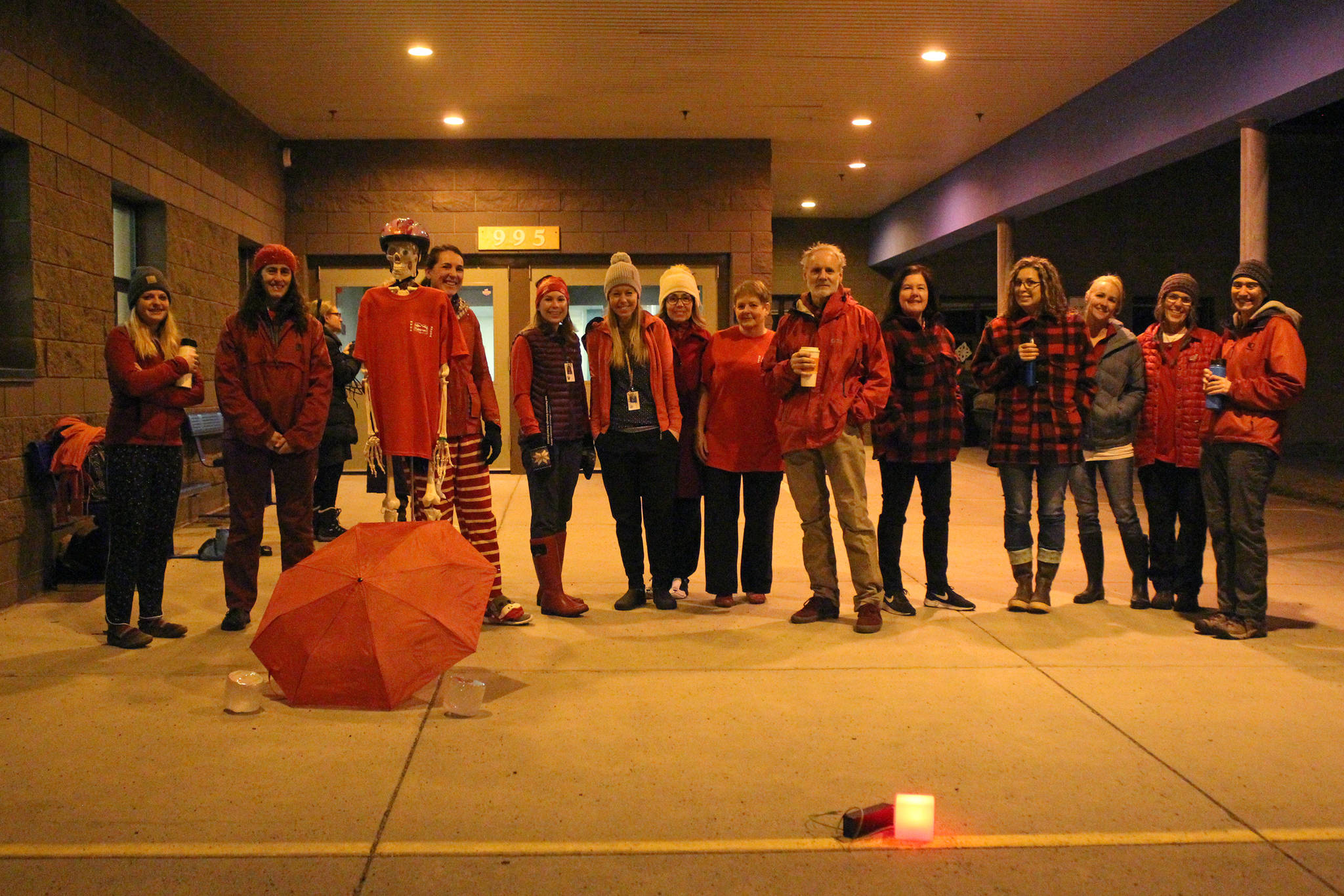 A group of teachers gather outside the entrance to West Homer Elementary and Big Fireweed Academy wearing “red for ed” Wednesday, in Homer. Teachers around the Kenai Peninsula demonstrated this week to bring awareness to the contract negotiation situation with the school district. (Photo by Megan Pacer/Homer News)