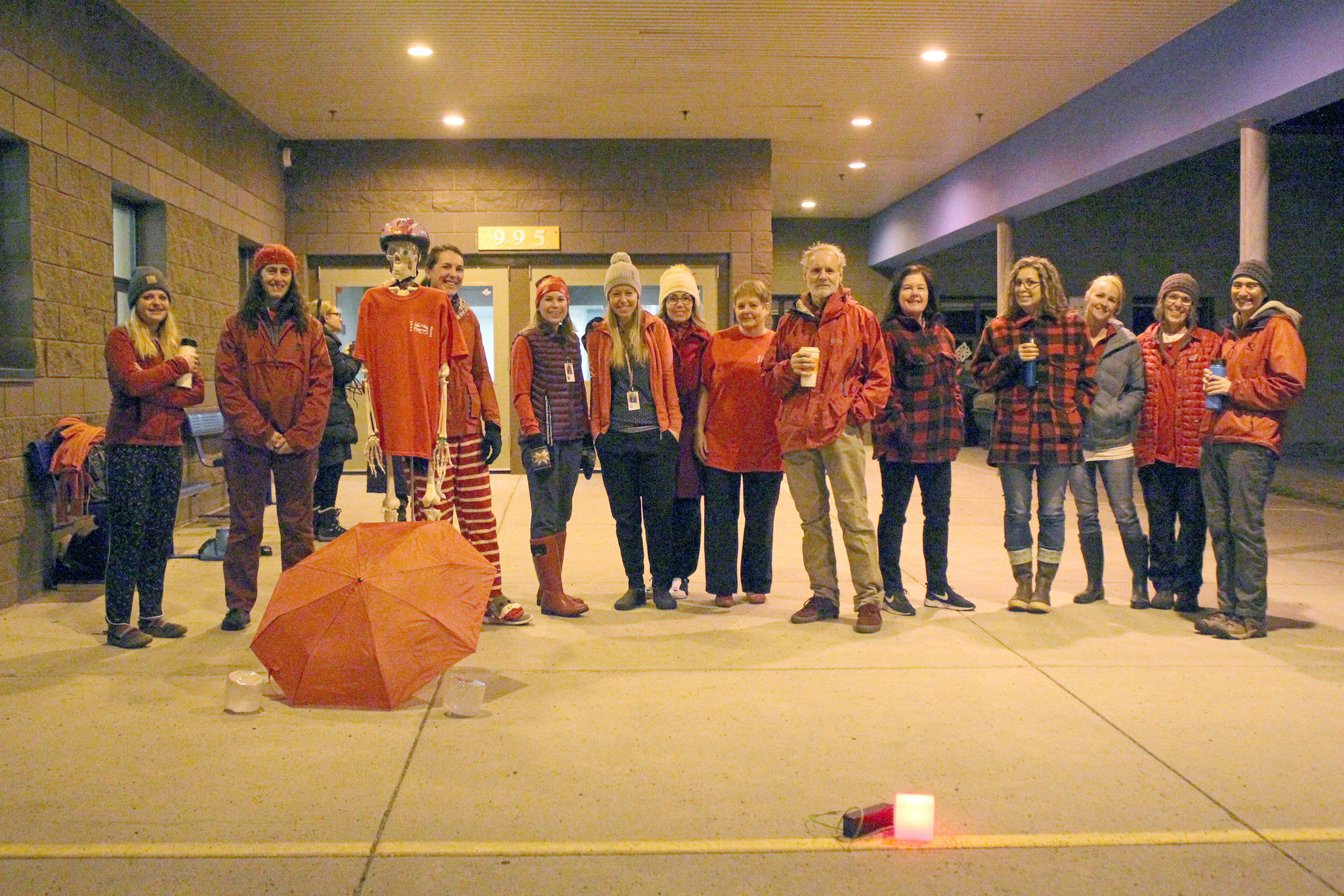 A group of teachers gather outside the entrance to West Homer Elementary and Big Fireweed Academy wearing “red for ed” Wednesday, in Homer. Teachers around the Kenai Peninsula demonstrated this week to bring awareness to the contract negotiation situation with the school district. (Photo by Megan Pacer/Homer News)