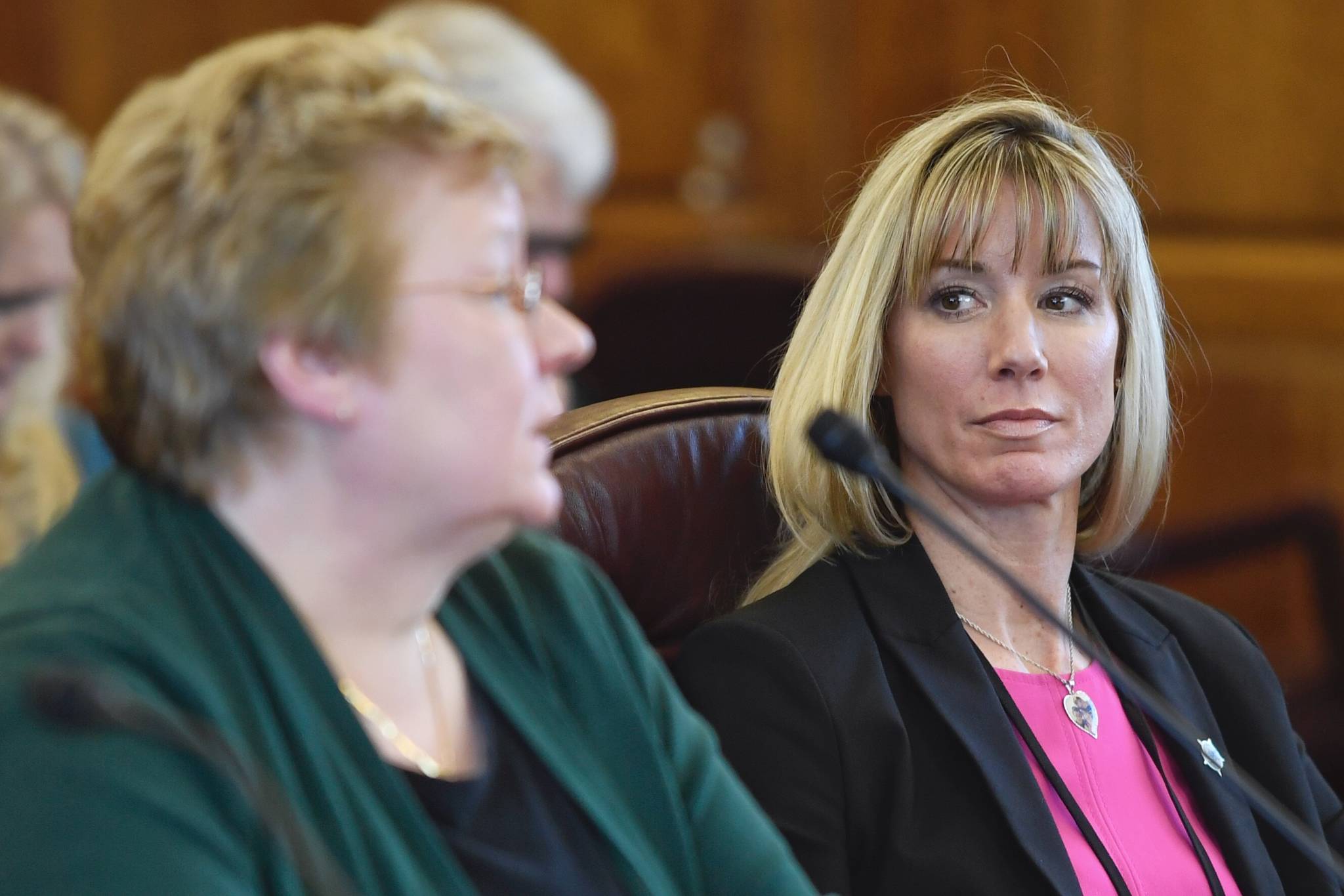 Amanda Price, commissioner of the Department of Public Safety, right, watches as Kathryn Monfreda, bureau chief of the Department of Public Safety’s Division of Statewide Services, presents the Uniform Crime Reporting Annual Report to House members during an informational meeting at the Capitol on Tuesday, Feb. 5, 2019. (Michael Penn | Juneau Empire)