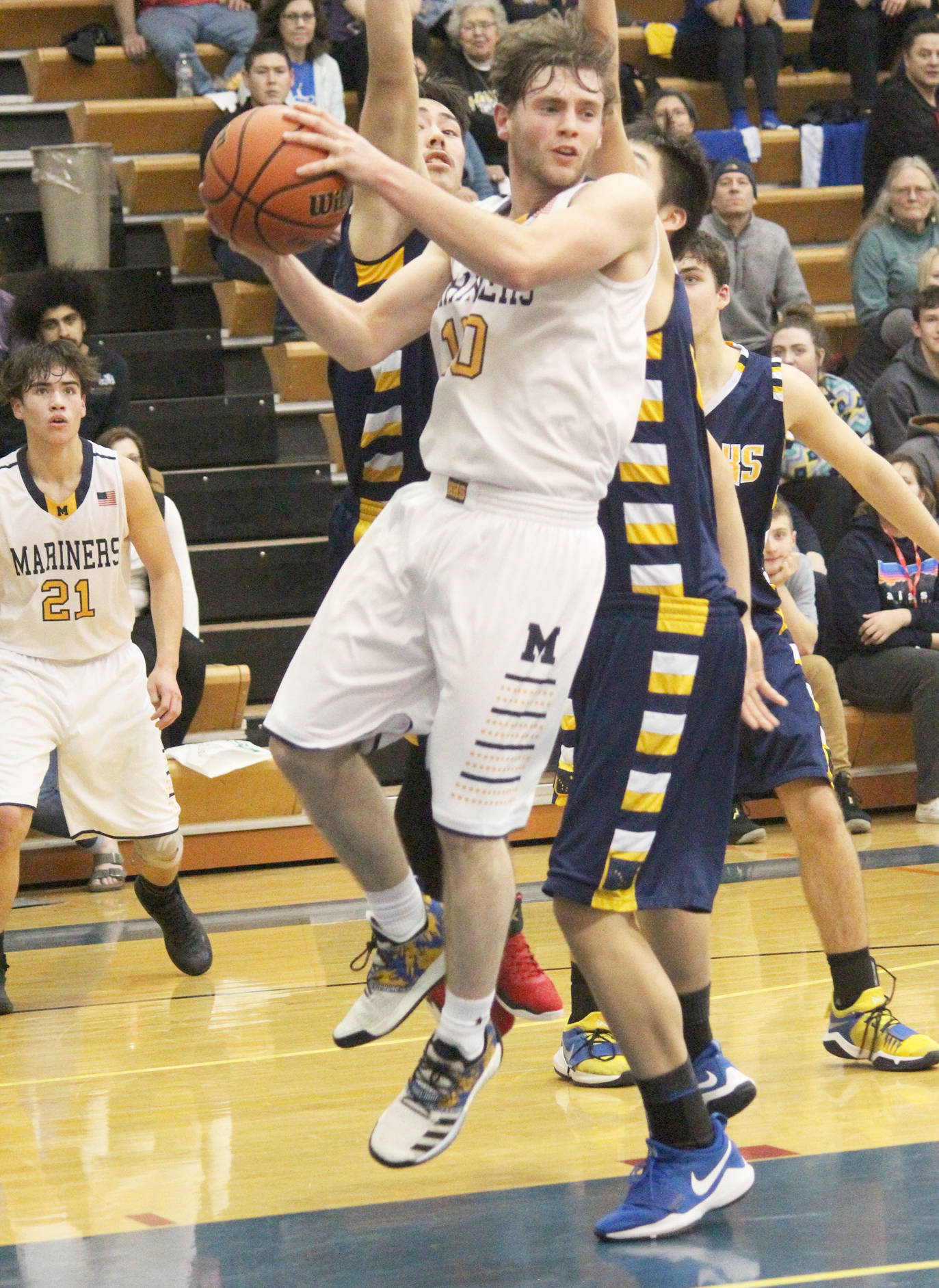 Homer’s Seth Adkins looks for a place to send the ball while under pressure from Galena players Thursday, Feb. 7, 2019 during the Winter Carnival Basketball Tournament in Homer, Alaska. (Photo by Megan Pacer/Homer News)