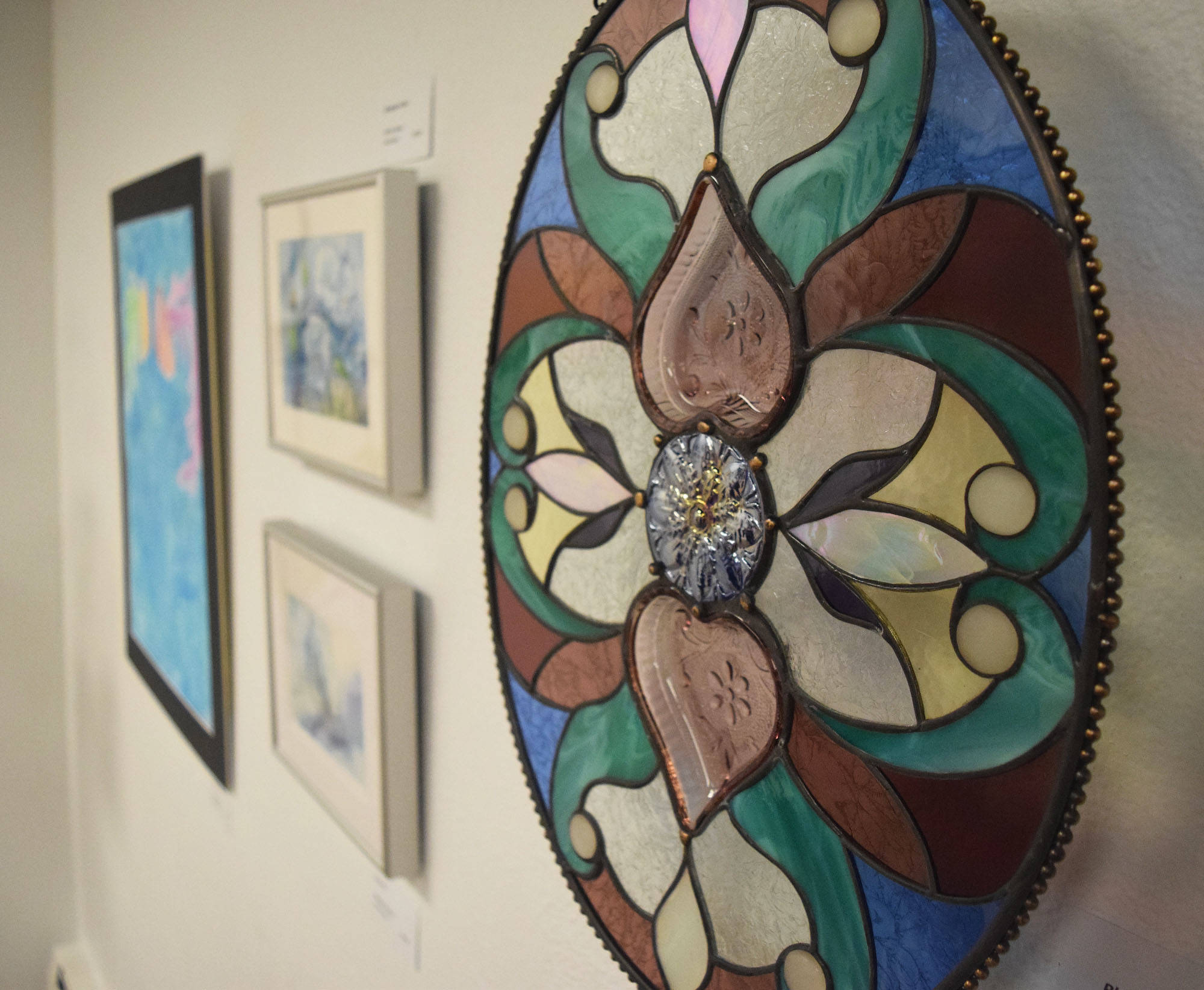 Art pieces hang on display for the “Show Us Your Heart” exhibit Thursday at the Kenai Fine Arts Center. (Photo by Joey Klecka/Peninsula Clarion)