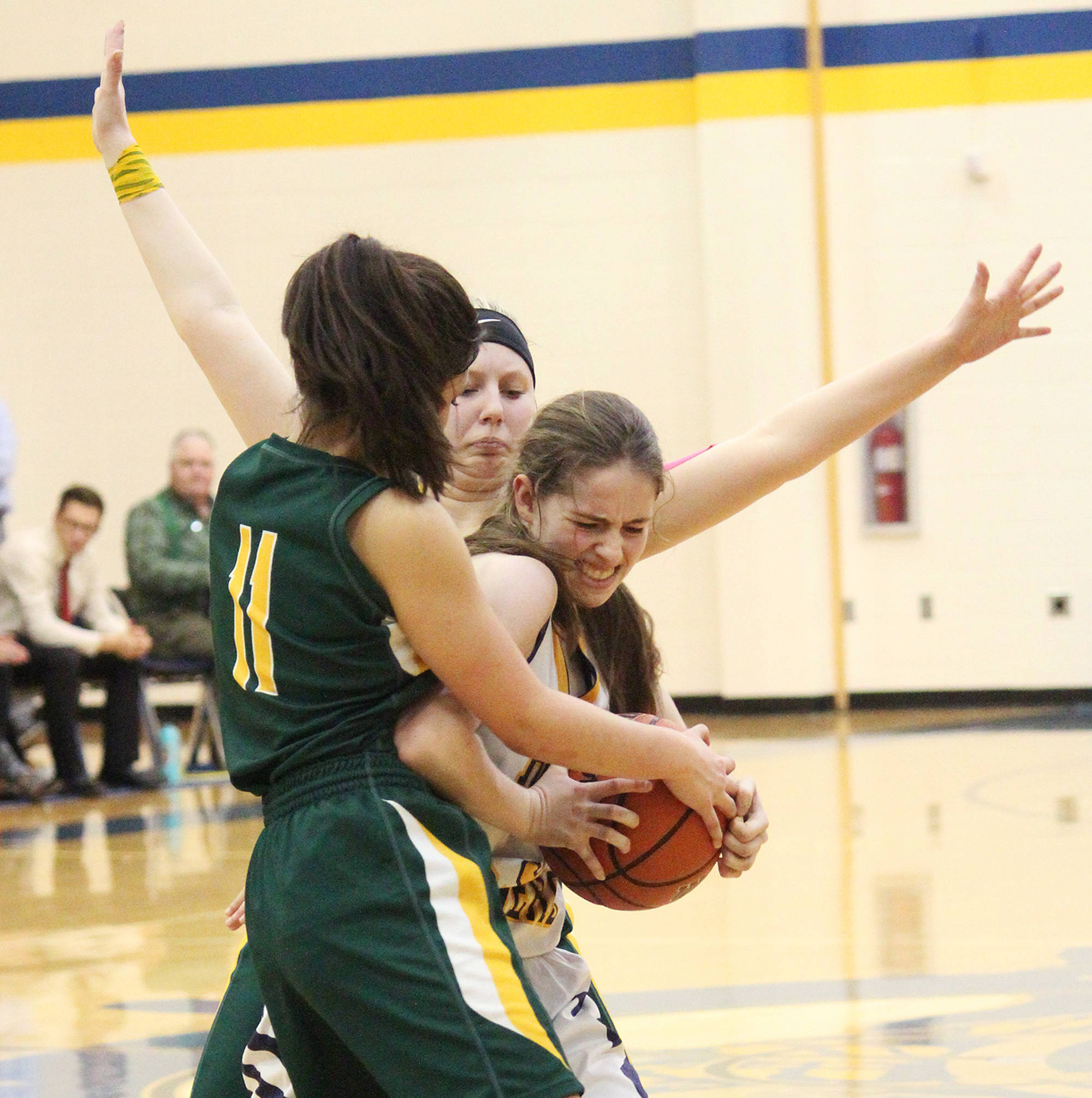 Homer’s Laura Inama tries to keep the ball away from Seward’s Anevay Ammbrosiani (No. 11) and Katelyn Lemme (background) Friday, Feb. 8, 2019 during the Winter Carnival Basketball Tournament in Homer, Alaska. (Photo by Megan Pacer/Homer News)
