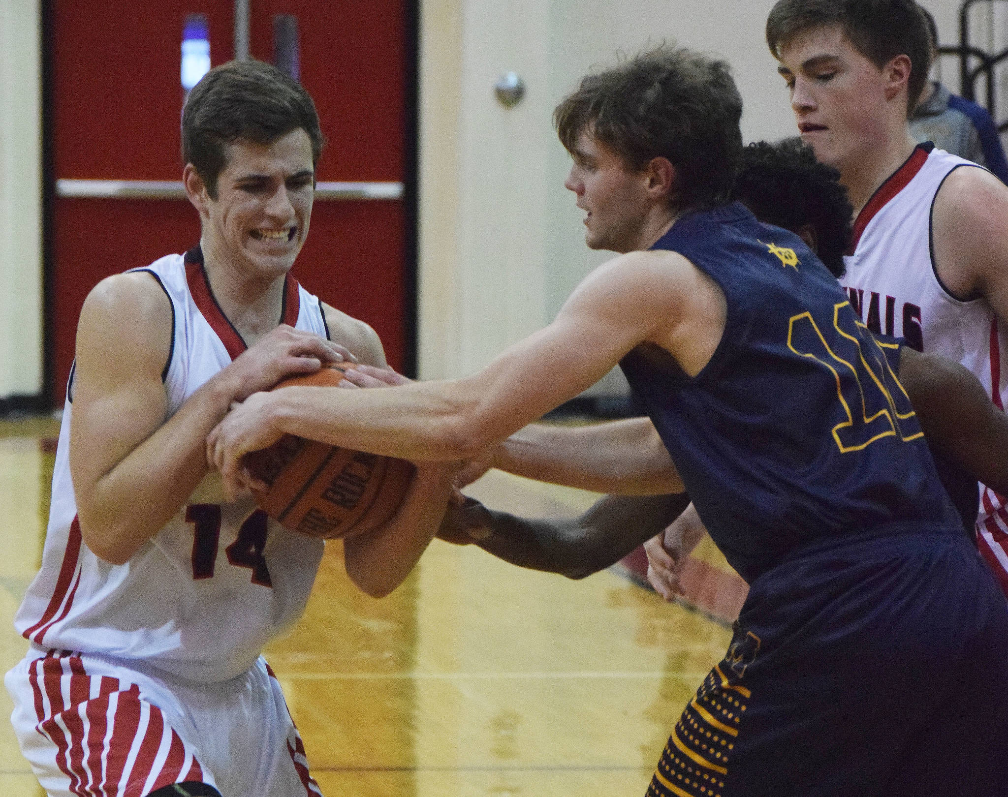 Kenai’s Logan Baker (left) wrestles the ball from Homer’s Seth Adkins Thursday in a conference clash at Kenai Central High School. (Photo by Joey Klecka/Peninsula Clarion)